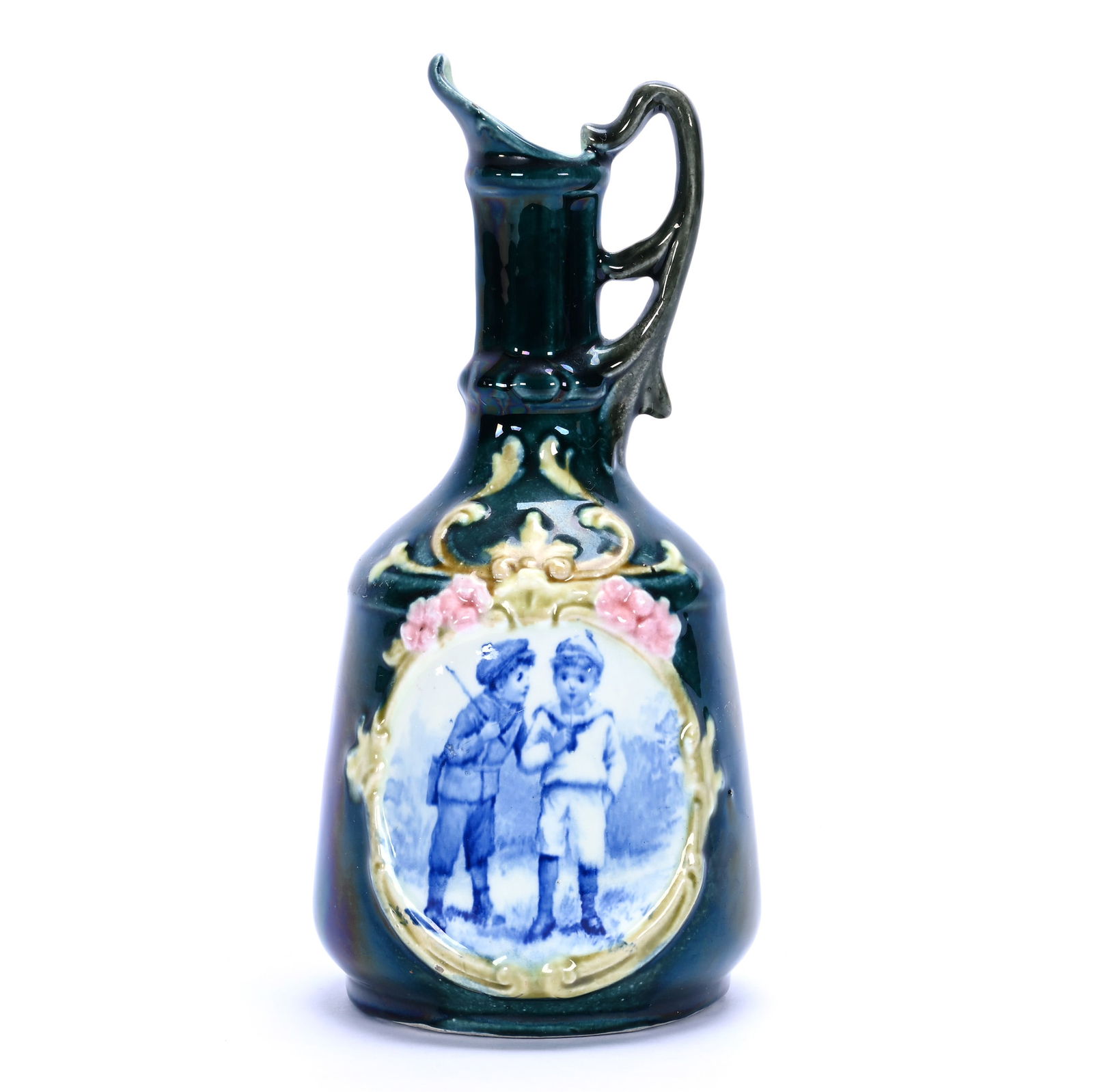 Ewer, Majolica Style Attributed To Josef Strnact, Austria: Ewer, Majolica Style Attributed To Josef Strnact, Austria, 9 x 4.25 x 4.25 Inches, Green Iridescent Background With Cobalt Blue And White Scene Of Two Boys, 0.8 Pounds, Colorado Private Collection.