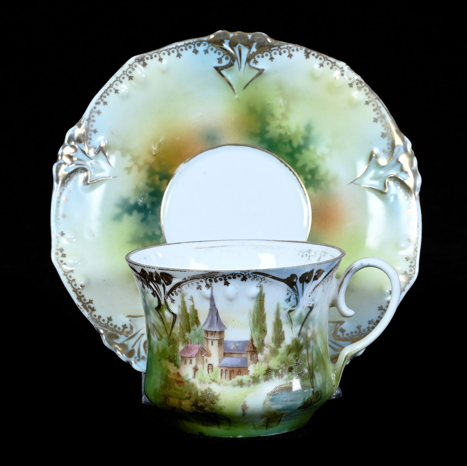 Cup And Saucer Marked R.S. Prussia, Point And Clover Mold: Cup And Saucer Marked R.S. Prussia, Point And Clover Mold, 2.5 x 5 x 5 Inches, Castle Scenic Decor, Hairline In Cup, 0.3 Pounds, Grady And Annette Hite Collection.