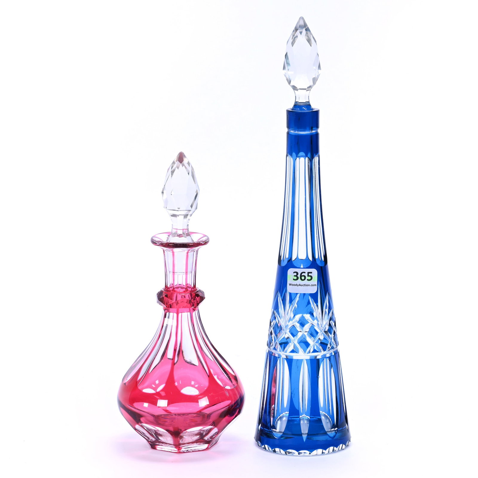 (2) Decanters, Brilliant Period Cut Glass, Color Cut To Clear With Gem Shaped Facet Cut Stoppers: (2) Decanters, Brilliant Period Cut Glass, Color Cut To Clear With Gem Shaped Facet Cut Stoppers, (1) 12.25" x 2.75" Blue Cut To Clear, Hard To See Rim Crack, (1) 8.5" x 3.75" Cranberry Cut To Clear,