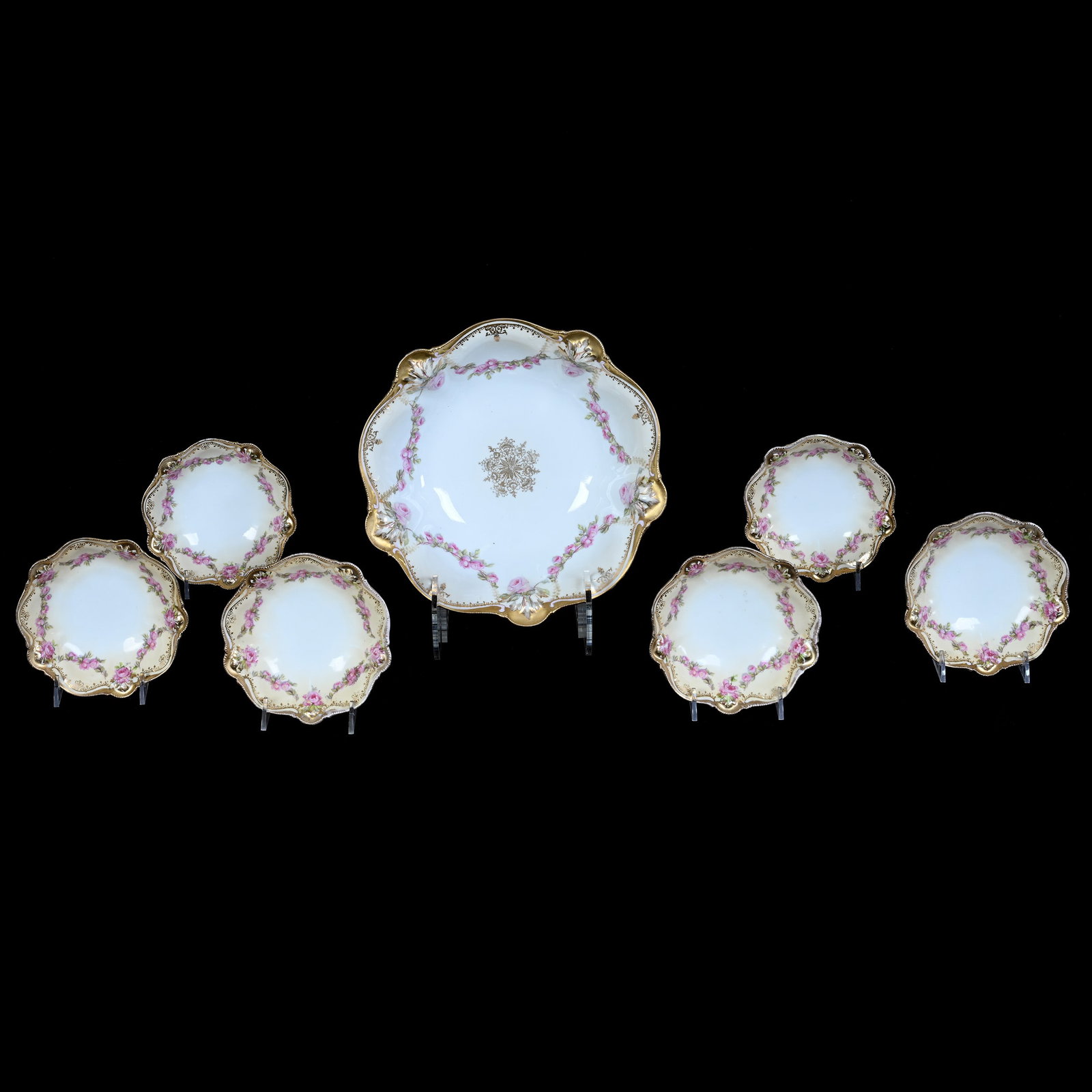Berry Set, Marked R.S. Prussia: Berry Set, Marked R.S. Prussia, 9.75 x 9.75 x 2.75 Inches, White And Cream Tones With Pink Rose Garland Decor And Heavy Gold Trim With (6) 5.25" Berry Dishes, 2.1 Pounds. LiveAuctioneers Invoices Must