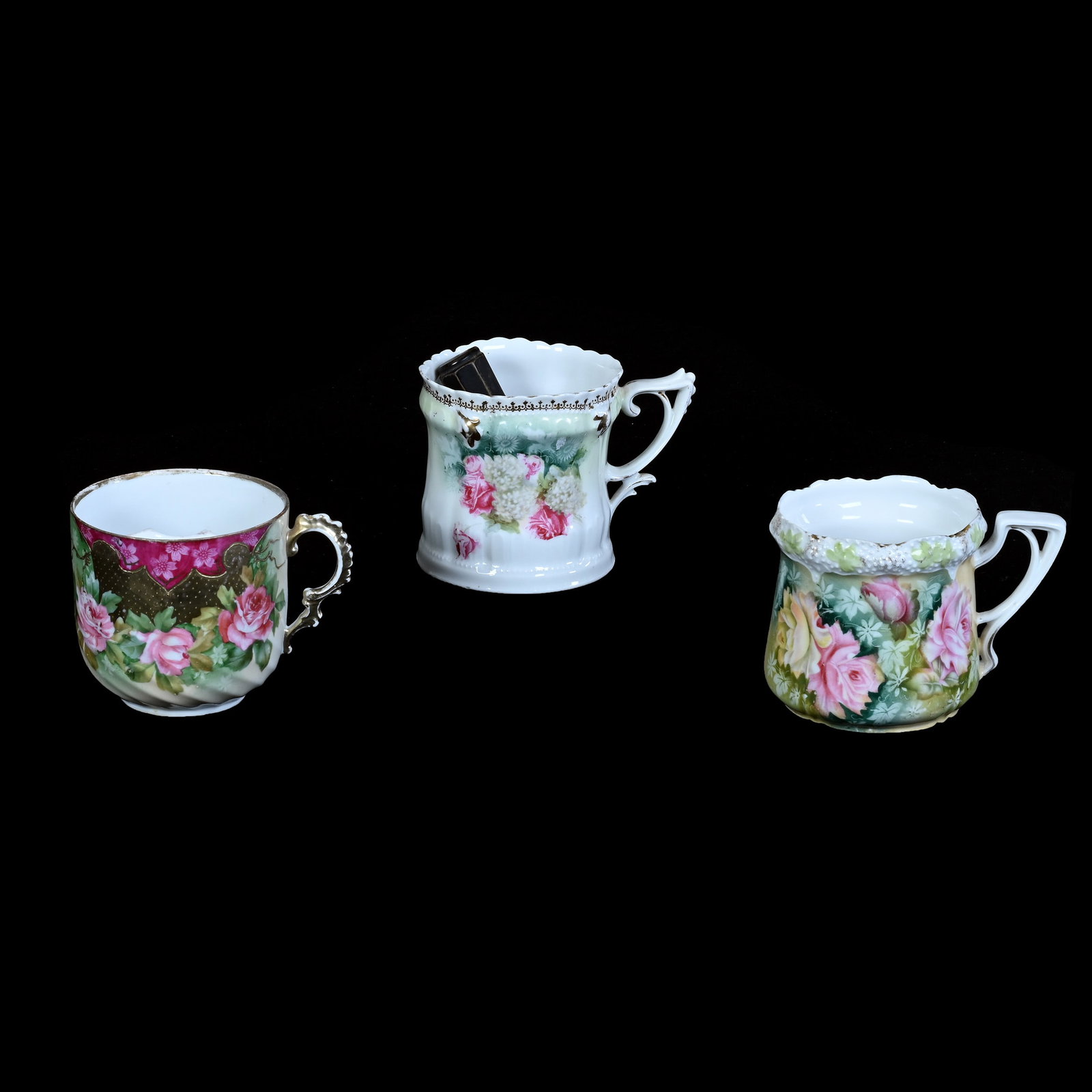 (3) Mugs, Prussia: (3) Mugs, Prussia, 3.5 x 4.75 x 3.5 Inches, (1) Stipple Mold, Unmarked, Cream And Green Tones With Rose Decor, (1) Mustache Cup Marked R.S. Prussia, Cream, Green, And White Tones With Pink Border And