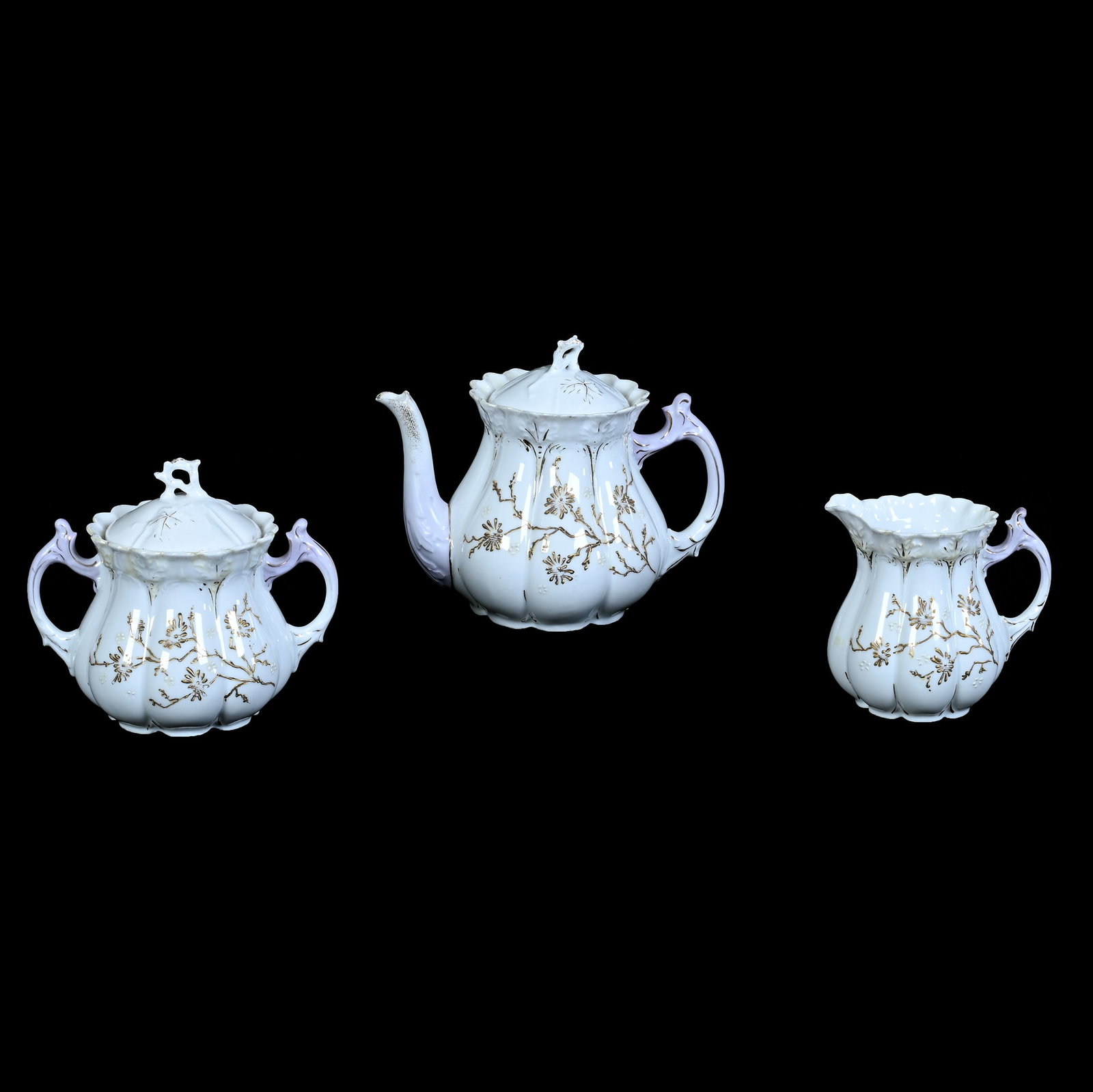 (3) Piece Tea Set, Unmarked R.S. Prussia: (3) Piece Tea Set, Unmarked R.S. Prussia, 5.5 x 7 x 4.75 Inches, White And Lavender With Enameled Floral Decor, Early Mold, Teapot With Creamer And Sugar, 1.4 Pounds. LiveAuctioneers Invoices Must Be 