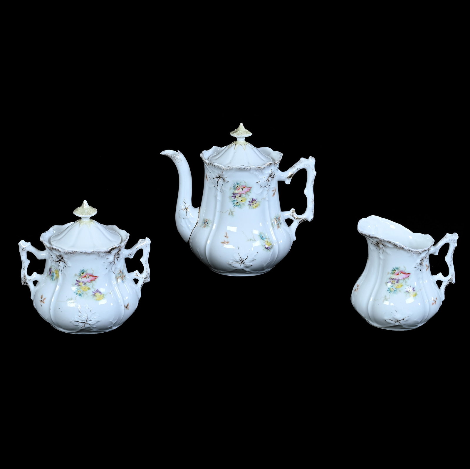 (3) Piece Tea Set, Unmarked R.S. Prussia, Leaf Mold: (3) Piece Tea Set, Unmarked R.S. Prussia, Leaf Mold, 6.25 x 6.5 x 4.25 Inches, White With Colorful Floral Decor, Teapot With Creamer And Sugar, 1.3 Pounds. LiveAuctioneers Invoices Must Be Paid Using
