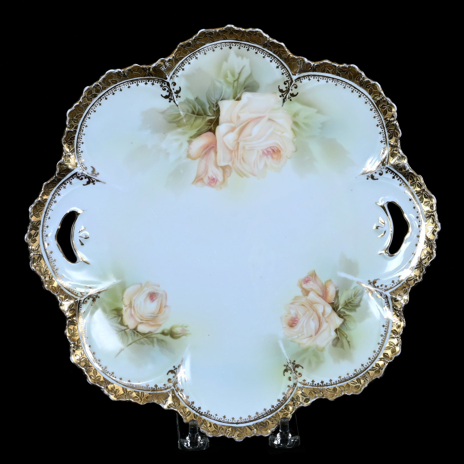 Two Handled Cake Plate, Marked R.S. Prussia: Two Handled Cake Plate, Marked R.S. Prussia, 10 x 10 x 1 Inches, White And Green Tones With Peach Rose Decor And Heavy Gold Trim, 0.9 Pounds. LiveAuctioneers Invoices Must Be Paid Using the PAY NOW /