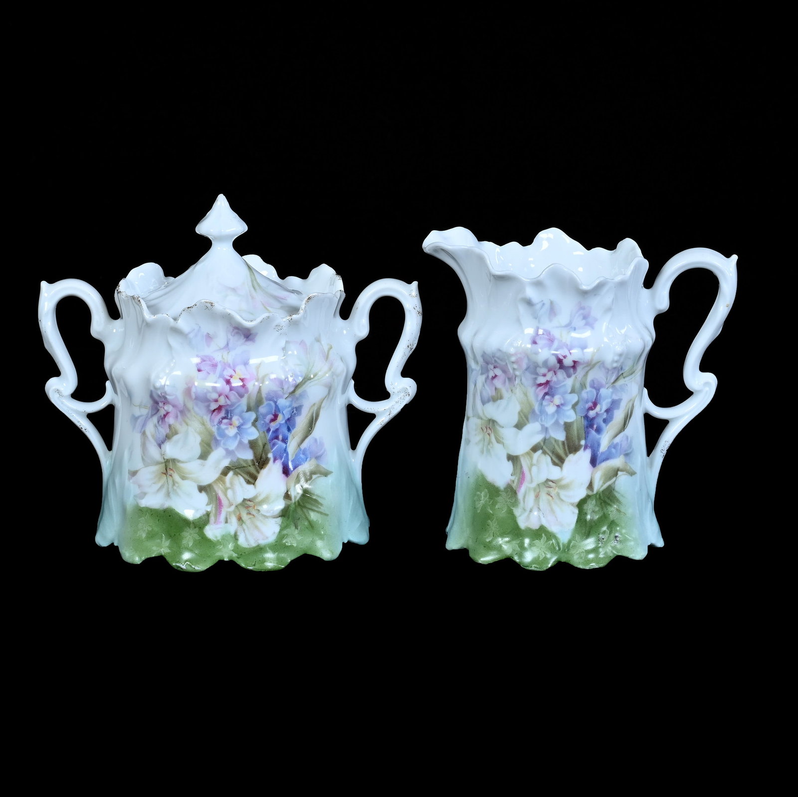 Creamer And Sugar, Unmarked R.S. Prussia: Creamer And Sugar, Unmarked R.S. Prussia, 5 x 5.25 x 4 Inches, Green, Blue, And White Tones With Easter Lily And Pastel Floral Decor, 0.8 Pounds. LiveAuctioneers Invoices Must Be Paid Using the PAY