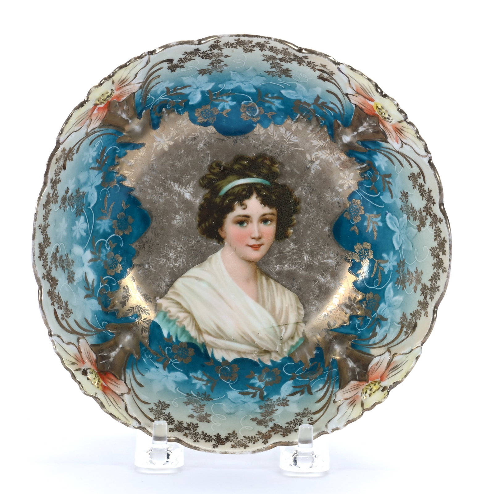 Cereal Bowl, Unmarked R.S. Prussia, Lily Mold: Cereal Bowl, Unmarked R.S. Prussia, Lily Mold, 6.25 x 6.25 x 2 Inches, Lebrun With Ribbon Portrait On Gold Background, Blue And Cream Border, Rim Chip, 0.4 Pounds. LiveAuctioneers Invoices Must Be