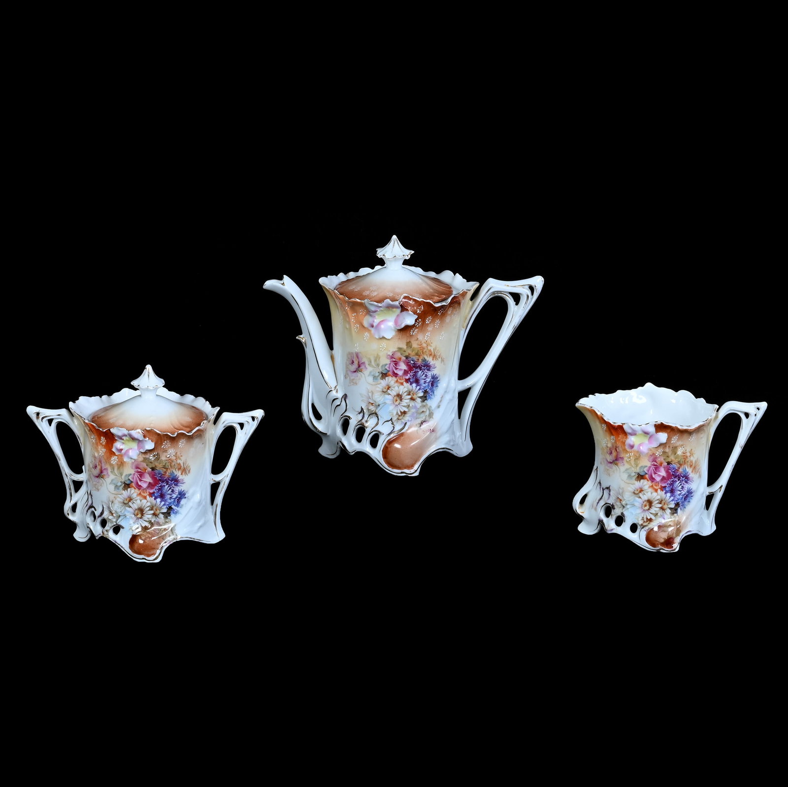 (3) Piece Tea Set, Unmarked R.S. Prussia: (3) Piece Tea Set, Unmarked R.S. Prussia, 6.25 x 7.75 x 4 Inches, Brown, Cream, And White Tones With Wild Floral Decor, 2 Pounds. LiveAuctioneers Invoices Must Be Paid Using the PAY NOW / CHECK OUT Bu