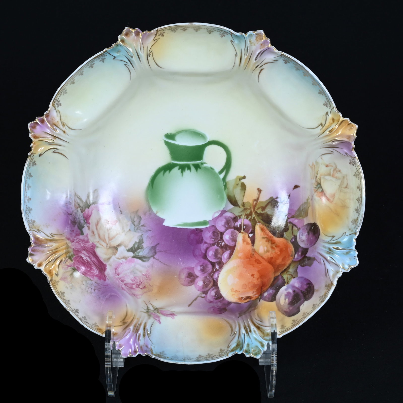 Bowl, Marked R.S. Prussia: Bowl, Marked R.S. Prussia, 10.75 x 10.75 x 3 Inches, Lavender, Orange, Yellow, And Blue Tones With Pitcher And Fruit Decor, Hairline Repair On Backside, 1.3 Pounds. LiveAuctioneers Invoices Must Be Pa