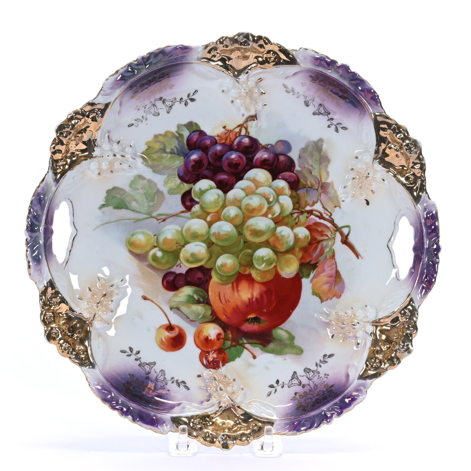 Two Handled Cake Plate, Unmarked Germany: Two Handled Cake Plate, Unmarked Germany, 11 x 11 x 1.5 Inches, Lavender And White Luster Finish With Fruit Decor And Gold Highlights, 1.2 Pounds. LiveAuctioneers Invoices Must Be Paid Using the PAY