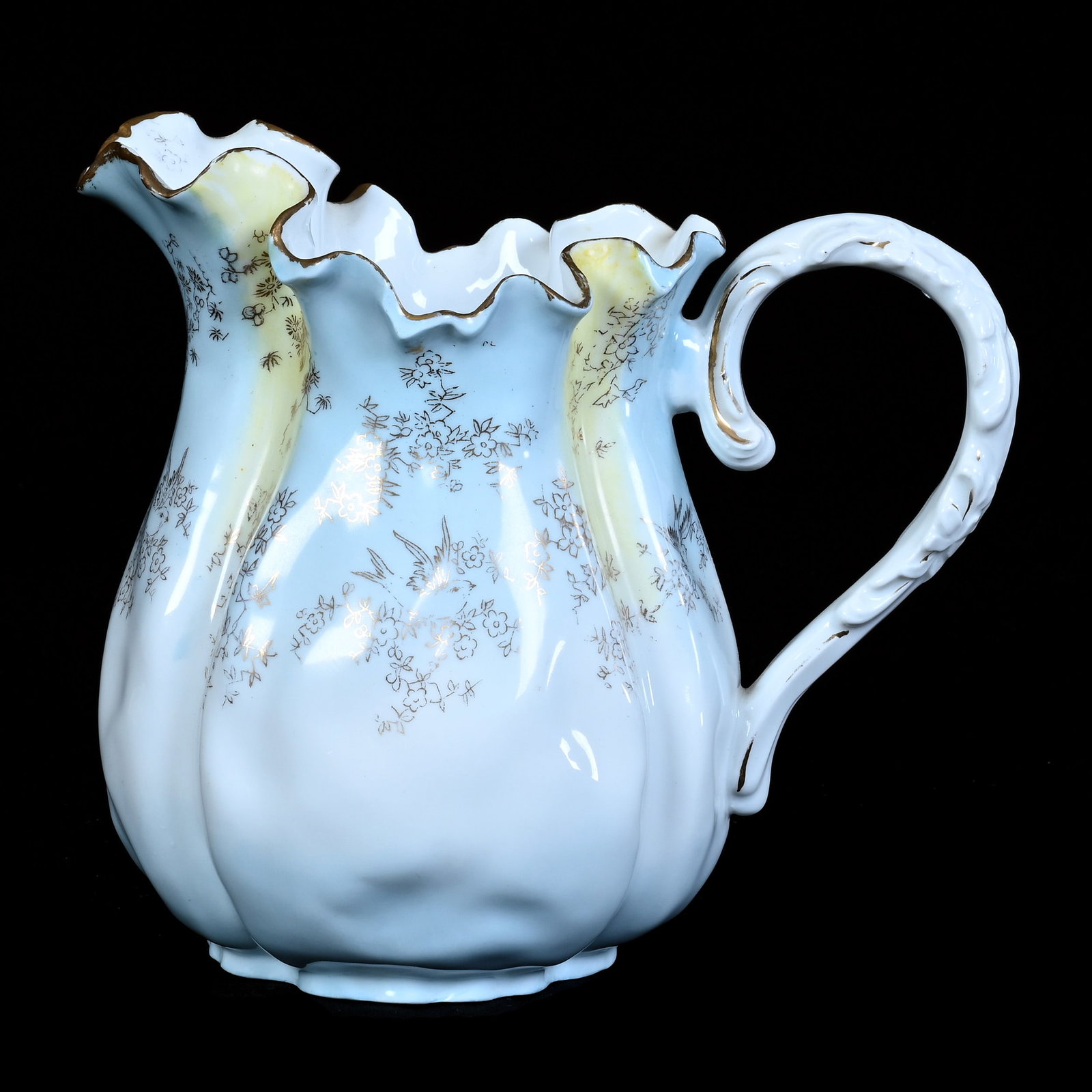 Pitcher, Early Unmarked Prussia: Pitcher, Early Unmarked Prussia, 8.25 x 9.25 x 6 Inches, Blue, Yellow, And White Tones With Gold Stencil Decor, Small Spout Chip With Gold Rim Touchup, 2.1 Pounds. LiveAuctioneers Invoices Must Be
