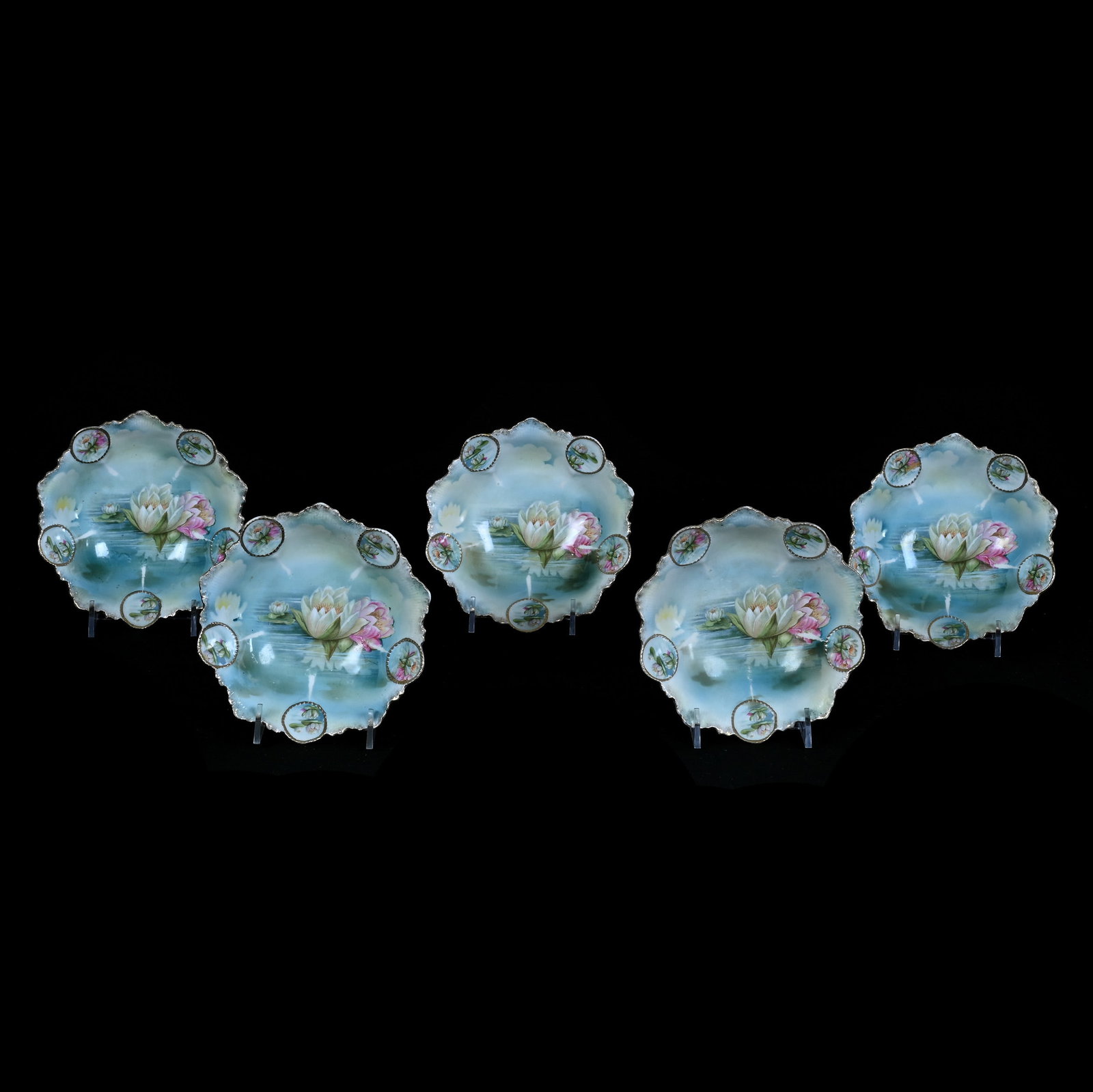 (5) Berry Bowls, Marked R.S. Prussia, Medallion Mold: (5) Berry Bowls, Marked R.S. Prussia, Medallion Mold, 5.5 x 5.5 x 1.5 Inches, Blue, Green, Yellow, And White Tones With Water Lily Decor, Has Some Stacking Wear, One Bowl With Rim Chip, 1.4 Pounds. Li
