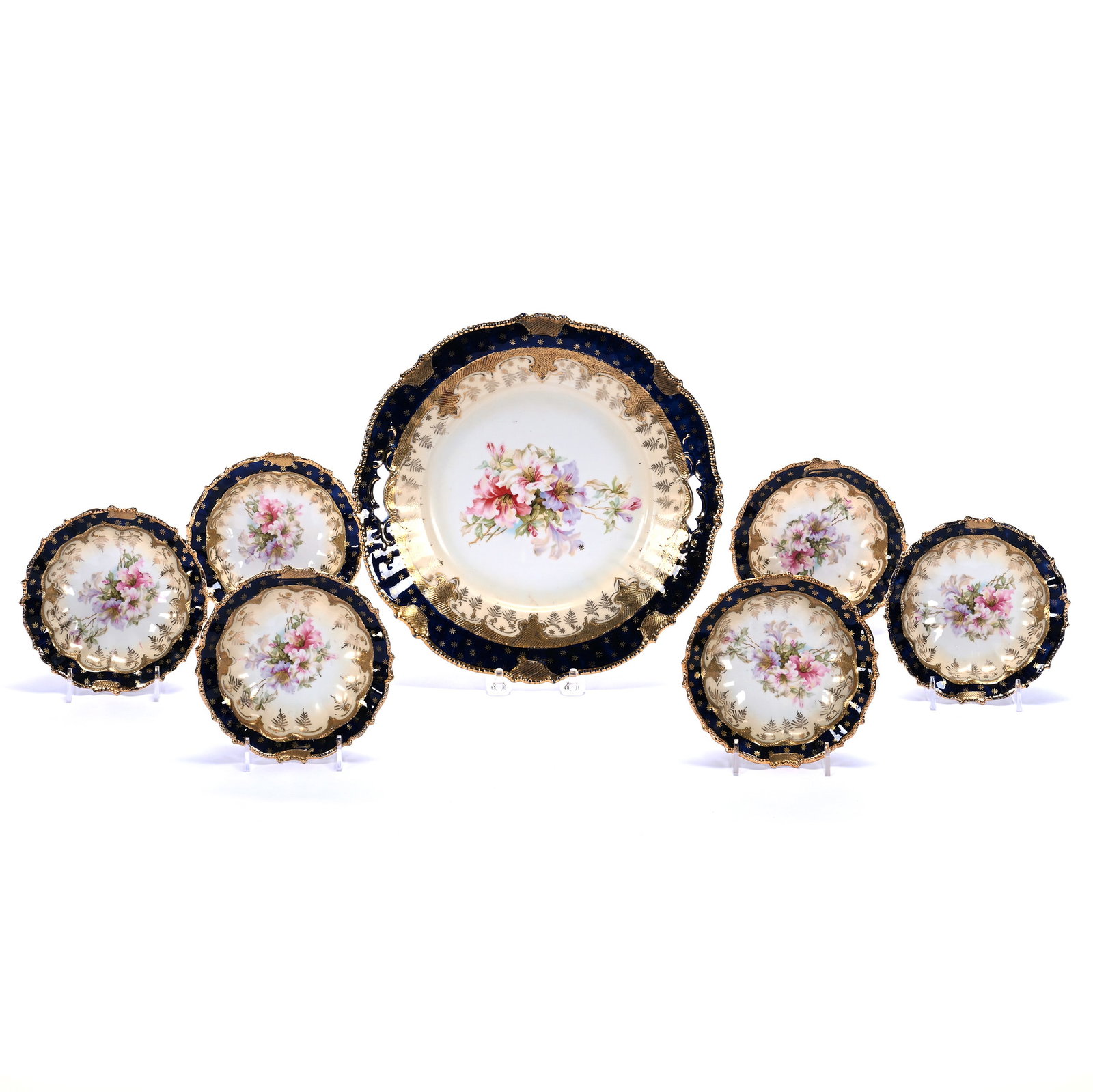 Two Handled Cake Plate And (6) Berry Bowls: Two Handled Cake Plate And (6) Berry Bowls, 11 x 11 x 1.5 Inches, Cream With Floral Decor, Cobalt Blue Border, Heavy Gold Highlights, 2.9 Pounds. LiveAuctioneers Invoices Must Be Paid Using the PAY NO