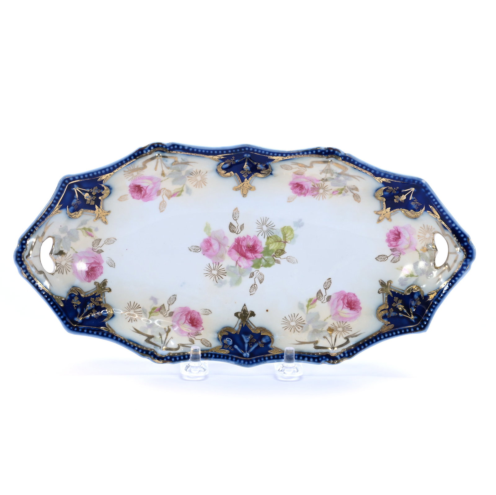 Relish Tray, Unmarked R.S. Prussia, Swag And Tassel Mold: Relish Tray, Unmarked R.S. Prussia, Swag And Tassel Mold, 9.75 x 4.75 x 1.25 Inches, Cream And White With Cobalt Blue Border And Pink Rose Decor, Gold Stencil Highlights, 0.4 Pounds. LiveAuctioneers