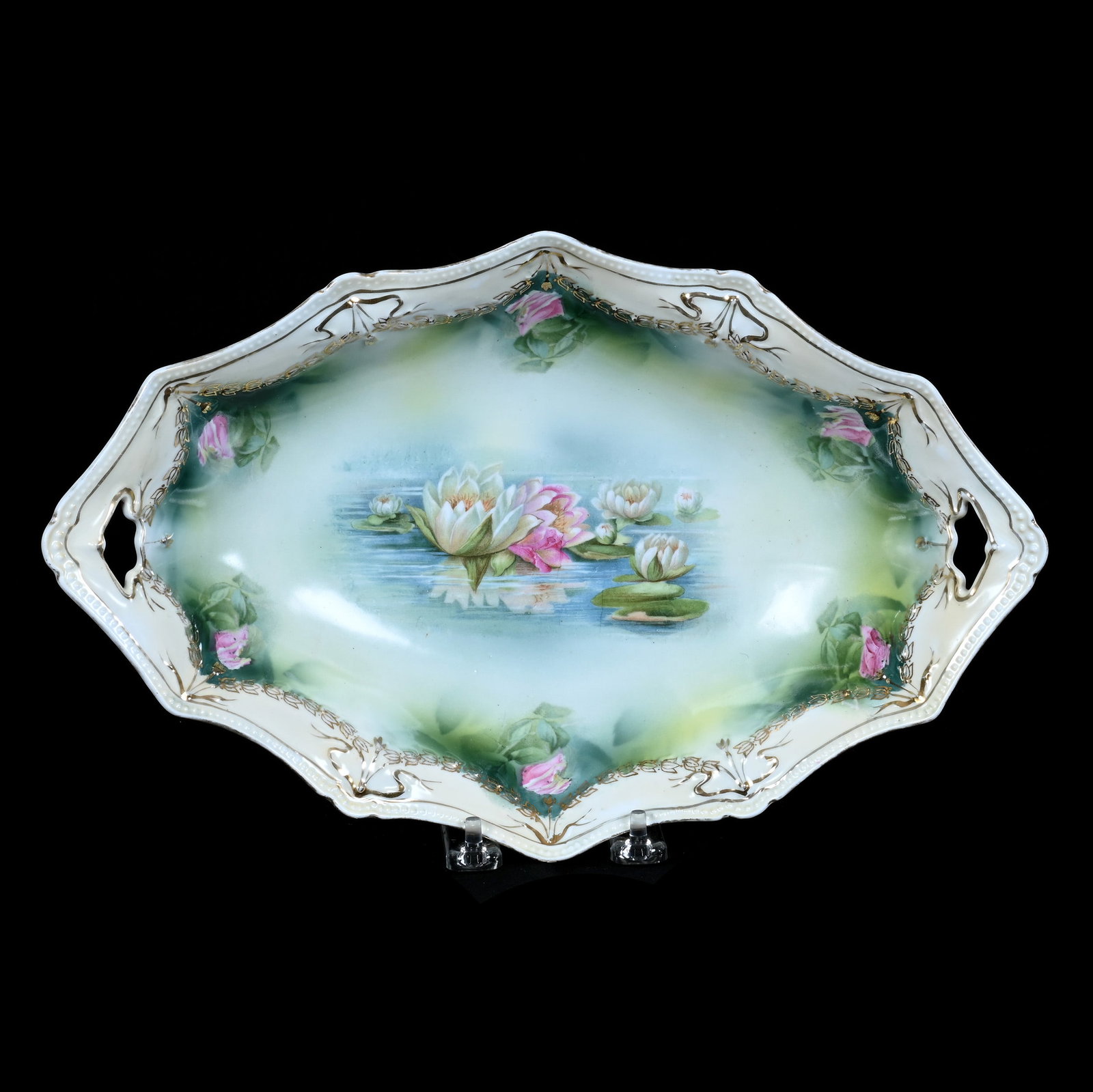 Bread Bowl, Unmarked R.S. Prussia, Swag And Tassel Mold: Bread Bowl, Unmarked R.S. Prussia, Swag And Tassel Mold, 13.25 x 8.5 x 2.75 Inches, Green And Cream Tones With Water Lily Decor, 1.2 Pounds. LiveAuctioneers Invoices Must Be Paid Using the PAY NOW /