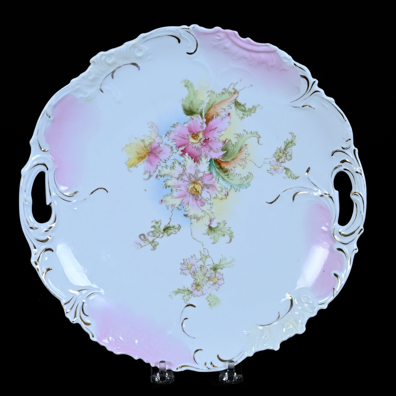 Two Handled Cake Plate, Unmarked R.S. Prussia: Two Handled Cake Plate, Unmarked R.S. Prussia, 11 x 11 x 1.5 Inches, Pink And White With Floral Decor, 1.2 Pounds. LiveAuctioneers Invoices Must Be Paid Using the PAY NOW / CHECK OUT Button Which
