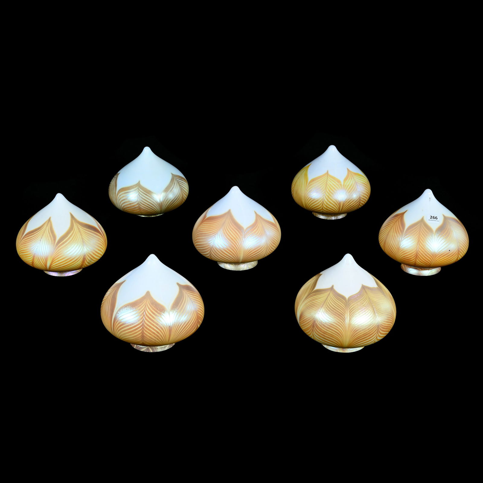 (7) Acorn Shaped Light Shades, Unmarked Quezal Style Art Glass: (7) Acorn Shaped Light Shades, Unmarked Quezal Style Art Glass, 6.25 x 7 x 7 Inches, White With Gold Iridescent Pulled Feather Design, 3" Diameter Shade Rings, Slight Size Variations Between Shades,