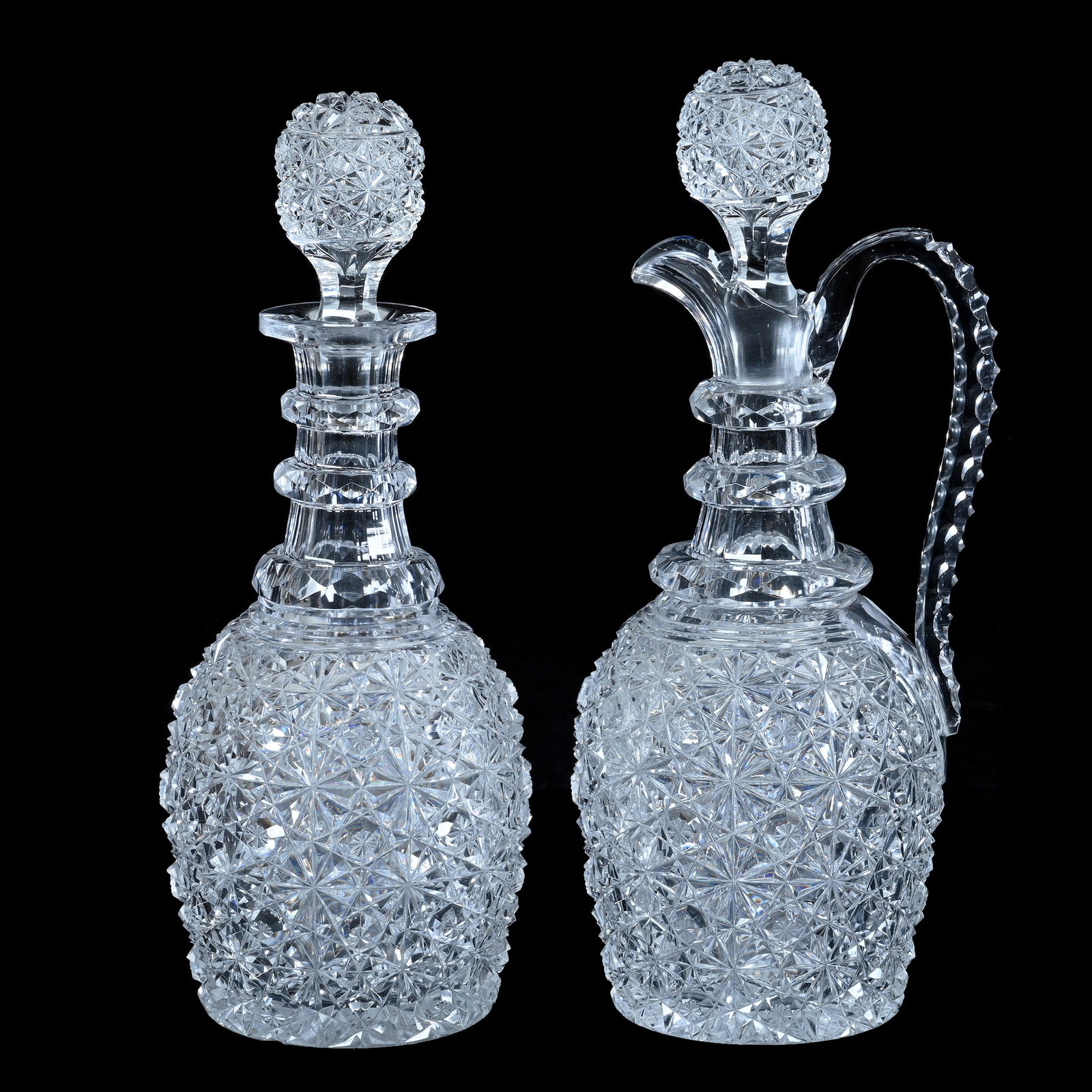 Pair Decanters, American Brilliant Cut Glass, Russian Pattern With Star Cut Buttons: Pair Decanters, American Brilliant Cut Glass, Russian Pattern With Star Cut Buttons, 12 x 5 x 4.75 Inches, Triple Facet Cut Ring Necks, Pattern Matched Stoppers, Ray Cut Bases, (1) With Triple