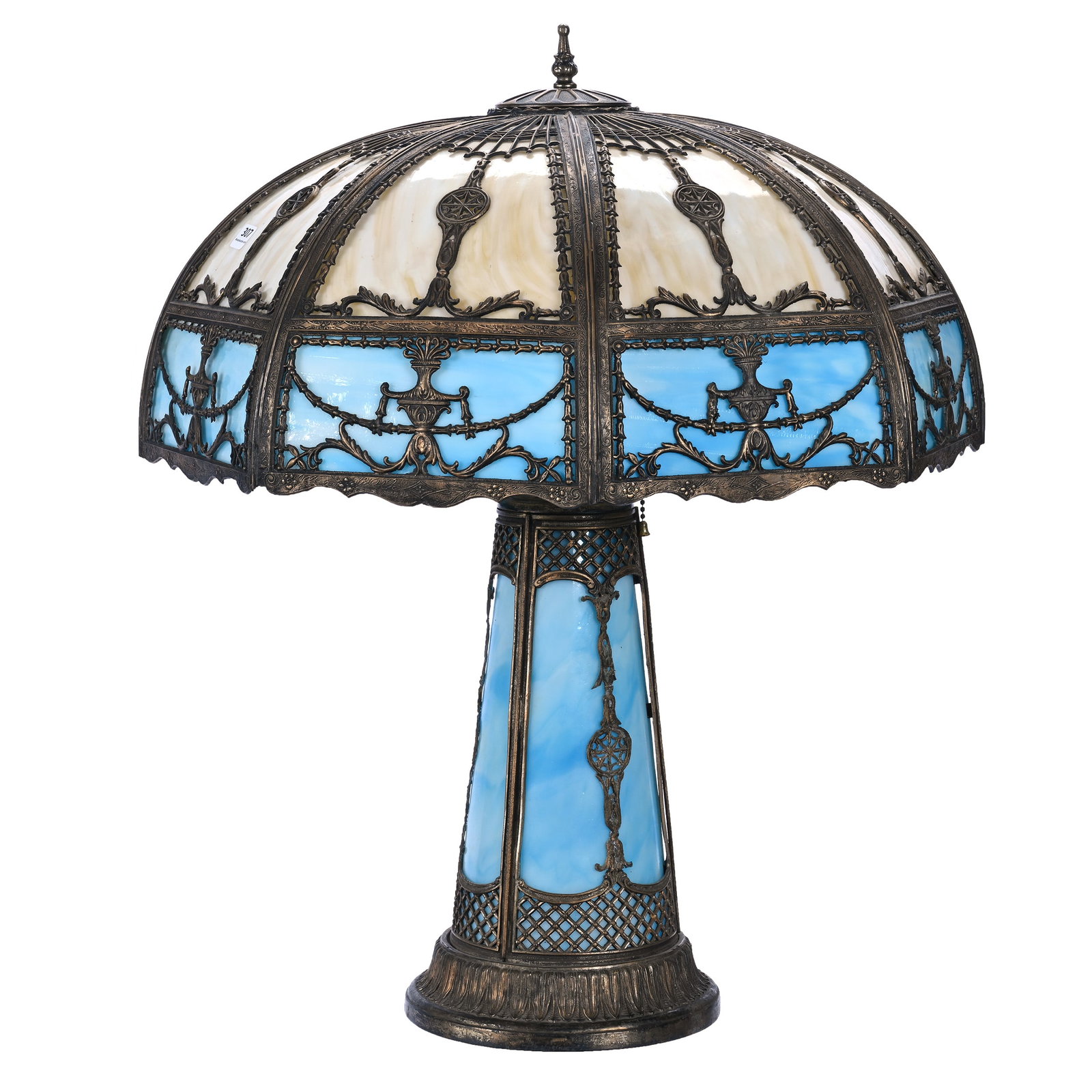 Table Lamp, Bent Panel Slag Glass, Blue And Caramel Colored Panels: Table Lamp, Bent Panel Slag Glass, Blue And Caramel Colored Panels, 24" x 19.5 x 19.5 Inches, Matching Panel Base, Electrified Four Light Top, Lighted Base, Two Retainer Clips On Shade Missing. Woody