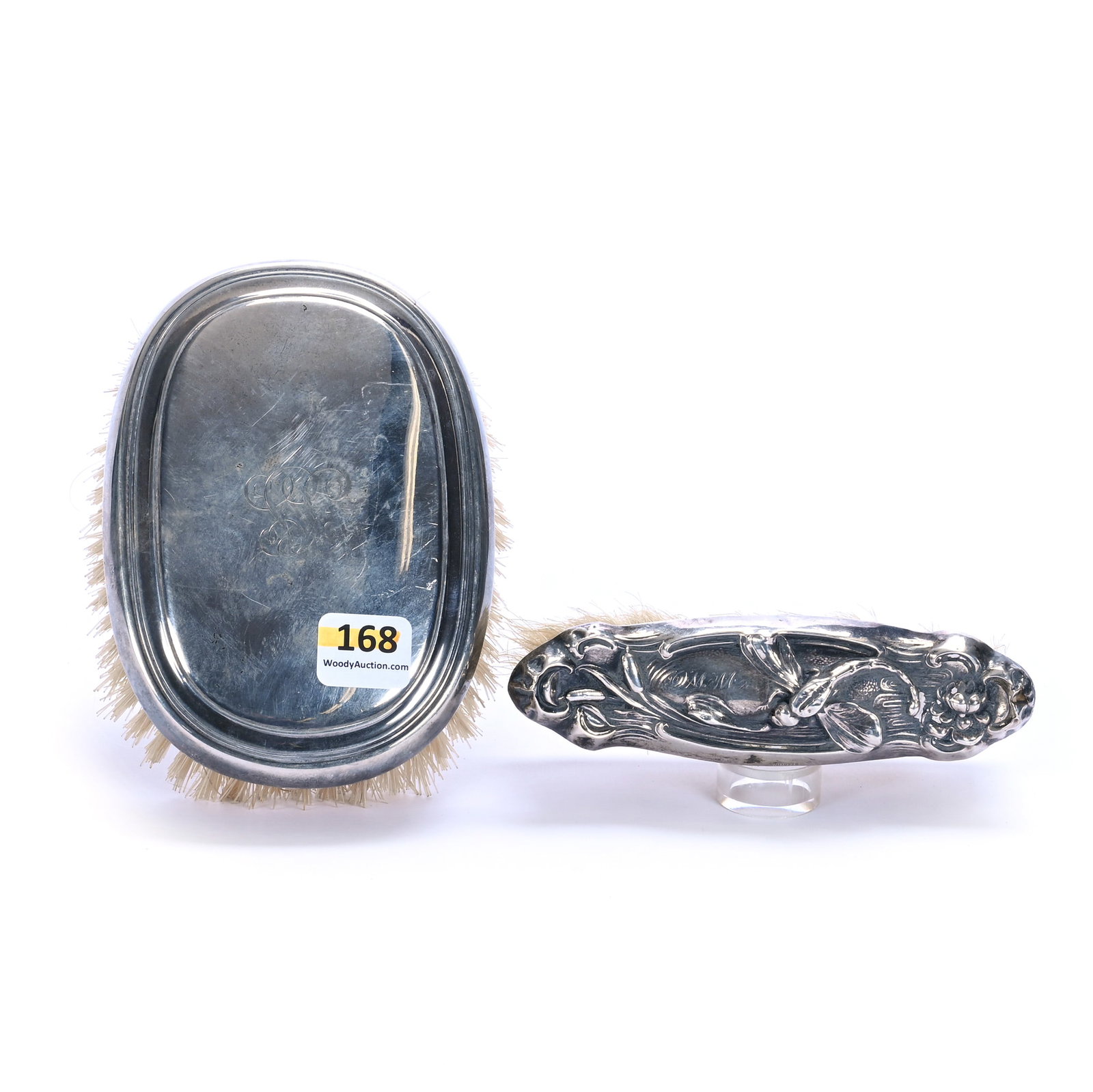 (2) Brushes With Sterling Tops: (2) Brushes With Sterling Tops, 5 x 3.75 x 2 Inches, (1) With Embossed Dragonfly And Water Lily Design, Both With Monograms, 0.5 Pounds, Grady and Annette Hite Collection, North Carolina. Effective