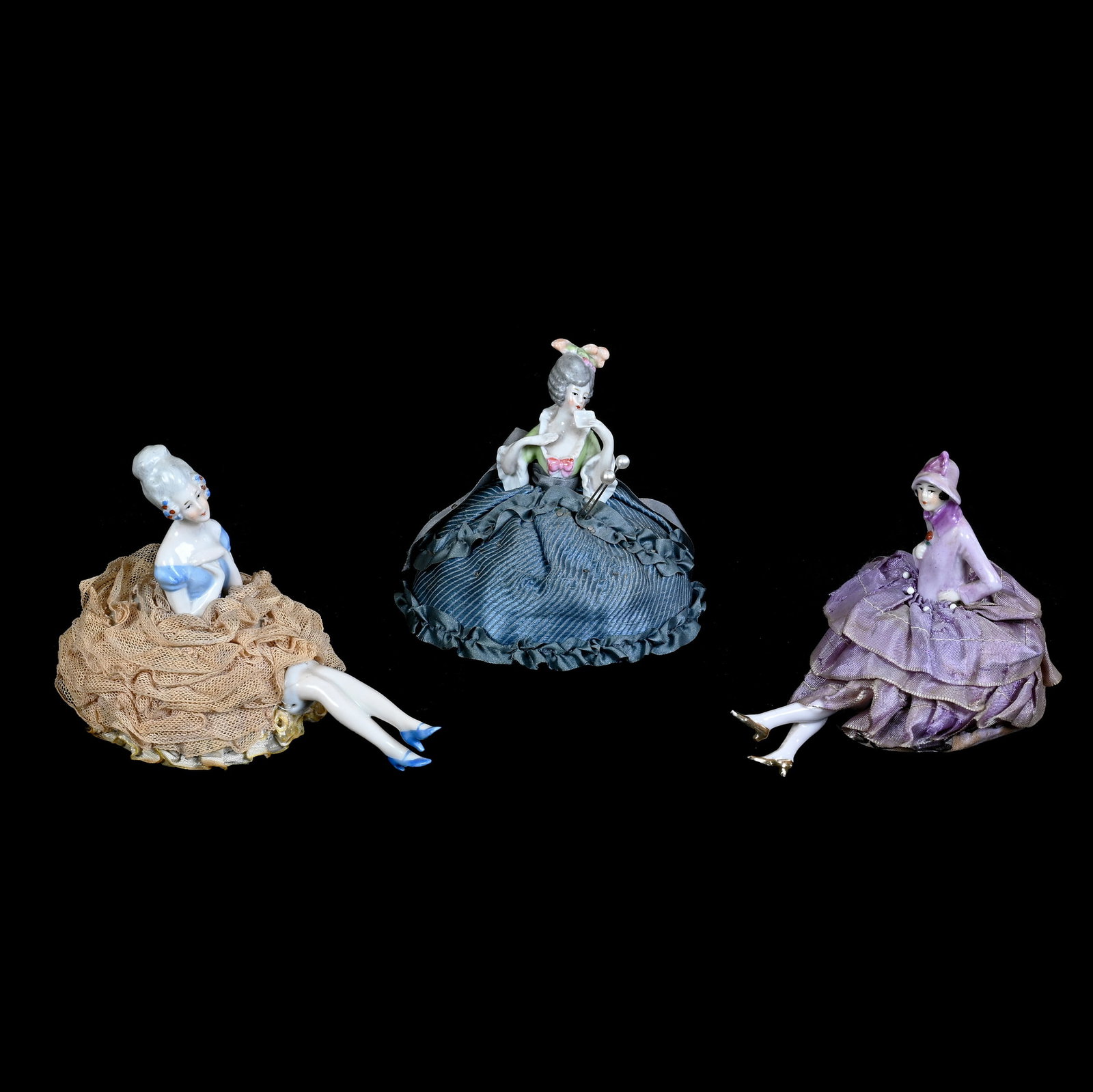 (3) Pin Cushion Dolls: (3) Pin Cushion Dolls, 4.5 x 6 x 4.5 Inches, Vintage Porcelain Heads, (2) With Original Legs, Nice Grouping, Blue And White Doll Has Small Hairline On Upper Leg, 0.4 Pounds, Grady and Annette Hite