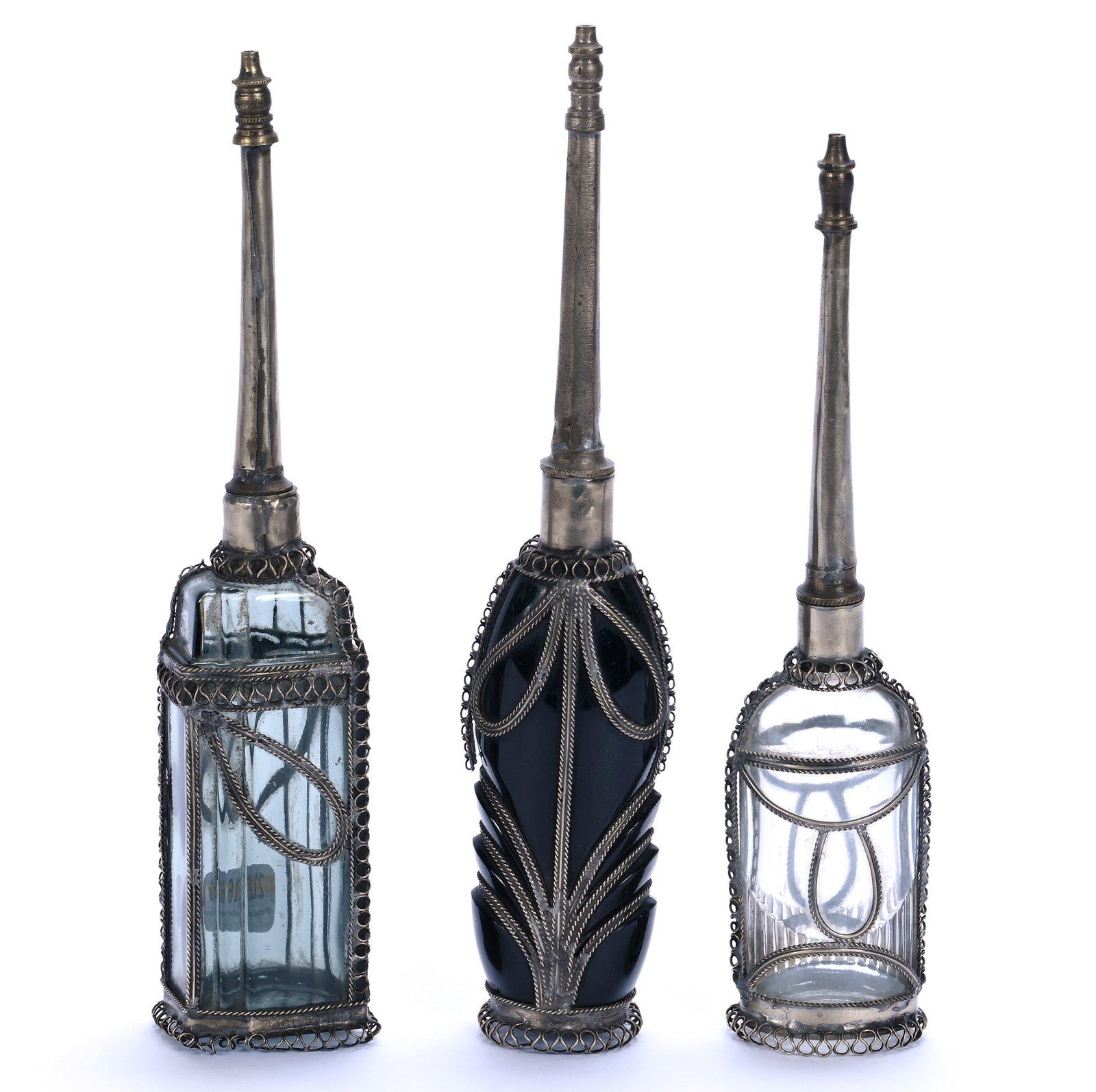 (3) Moroccan Rose Water Bottles: (3) Moroccan Rose Water Bottles, 10.5 x 2 x 2 Inches, Made In Marrakesh Circa 1920s, (2) Dark Smoke/Amethyst Bottle, (1) Clear, Smallest Has 9.75" Height, 1.4 Pounds, Grady and Annette Hite