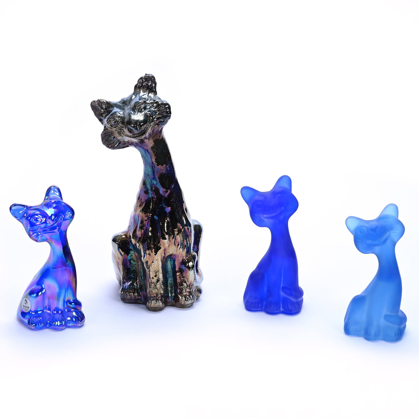 (4) Alley Cat Figures By Fenton (Also Known As Winking/Smiley Cat): (4) Alley Cat Figures By Fenton (Also Known As Winking/Smiley Cat) , 10.75 x 5.5 x 4 Inches, (1) Iridescent Black Amethyst, (1) 6" Cat Marked FAGCA (Fenton Art Glass Collectors Of America), Cobalt Sat