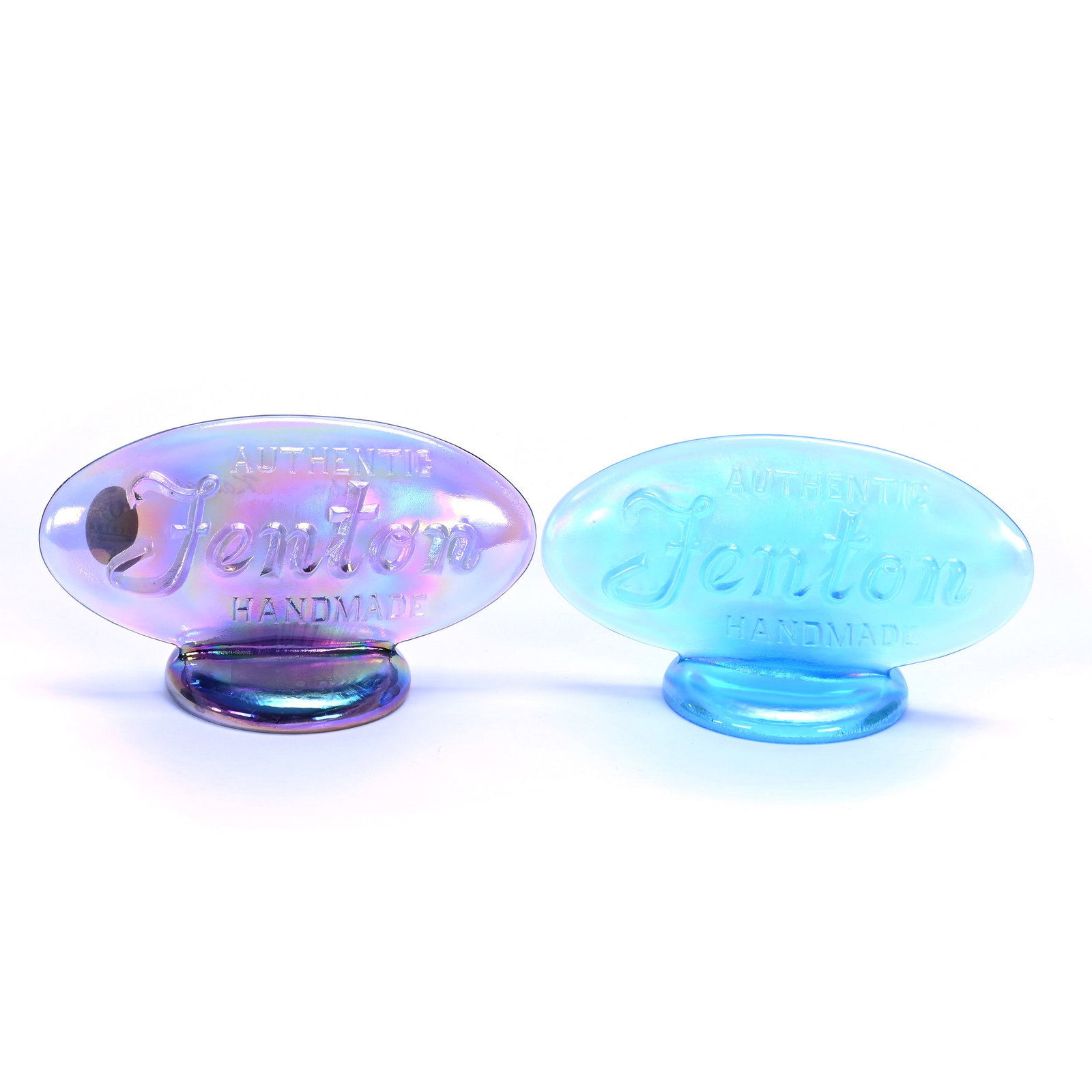 (2) Oval Dealer Signs, Fenton Art Glass: (2) Oval Dealer Signs, Fenton Art Glass, 5 x 2.5 x 2.75 Inches, (1) Iridescent Amethyst And (1) Iridescent Blue, 0.8 Pounds, Private Collection, Missouri. Effective 6/6/26, All LiveAuctioneers Invoice