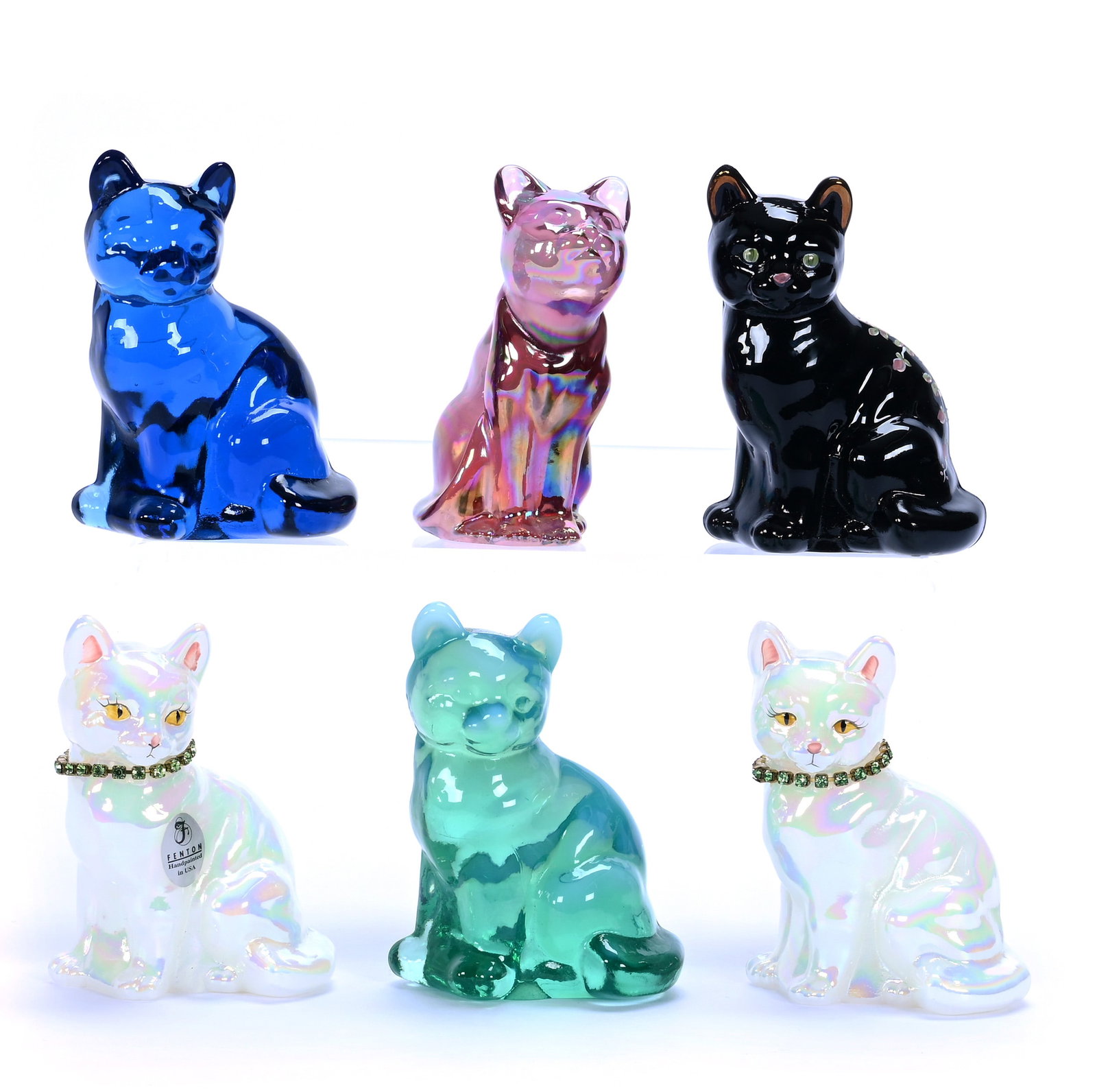 (6) Sitting Cat Figures, Fenton Art Glass: (6) Sitting Cat Figures, Fenton Art Glass, 3.75 x 2.75 x 2 Inches, Includes (2) Iridescent White With Jeweled Collar, (1) Black Amethyst, (1) Cobalt Blue, (1) Iridescent Pink, And (1) Green Opalescent