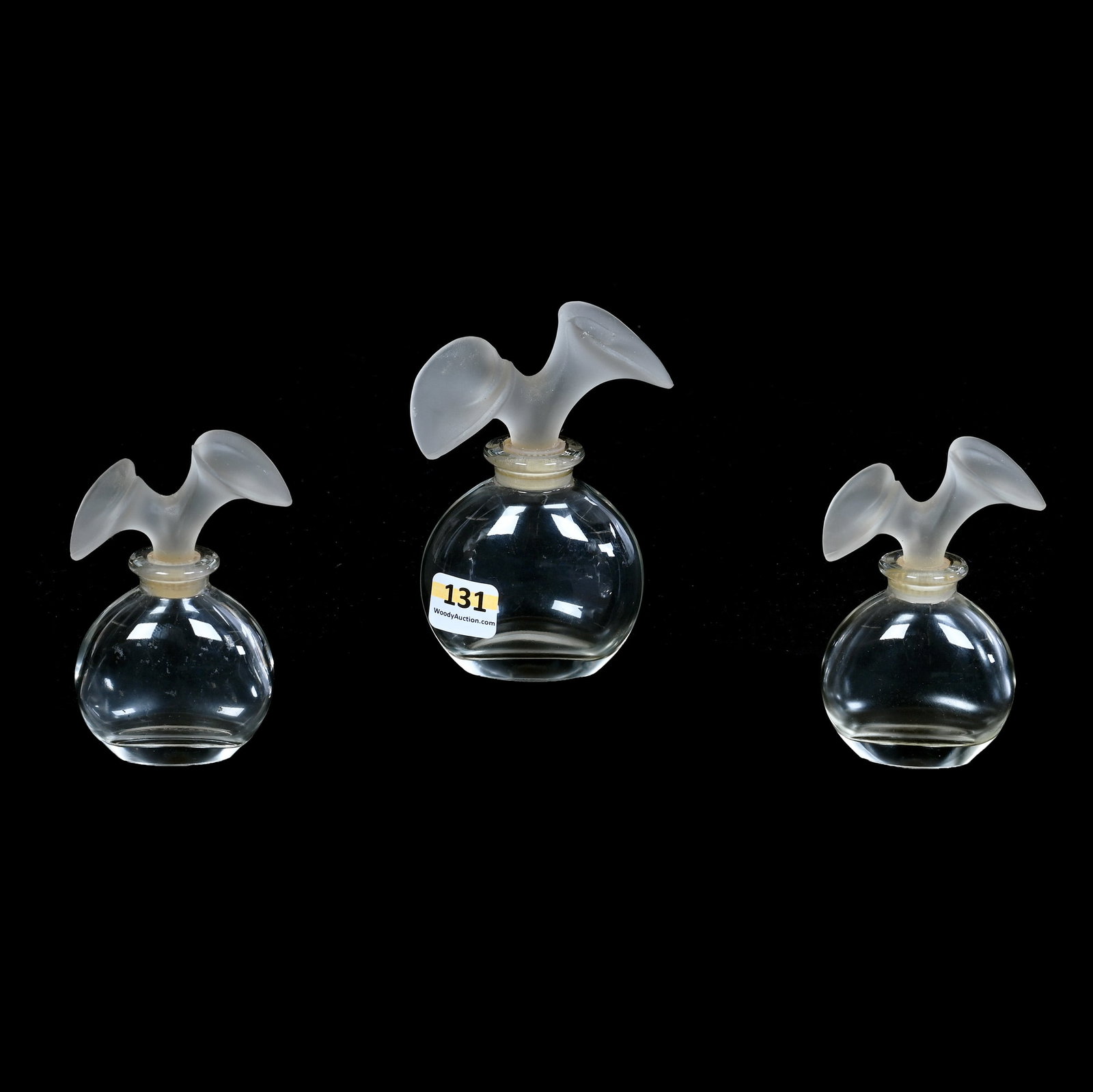(3) Perfume Bottles, Marked Made In France, Designed By Karl Lagerfeld: (3) Perfume Bottles, Marked Made In France, Designed By Karl Lagerfeld, 4.5 x 2.75 x 1.75 Inches, Clear With Frosted Cala Lily Shaped Stoppers, (2) 3.75" Tall, Large Stopper Has Rim Nick, 0.8 Pounds, 
