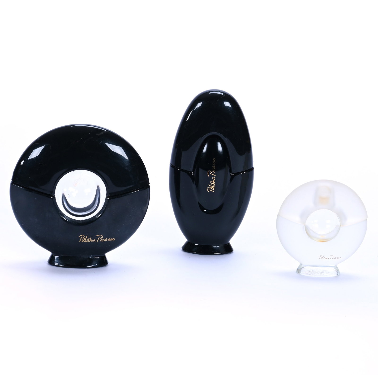 (3) French Perfume Bottles, Paloma Picasso: (3) French Perfume Bottles, Paloma Picasso, 5.5 x 2.75 x 1.25 Inches, (1) All Black, (1) 4.5" Circular Black With Clear Center, And (1) 3.25" Circular Clear Frosted Glass With Clear Center, 1.1 Pounds