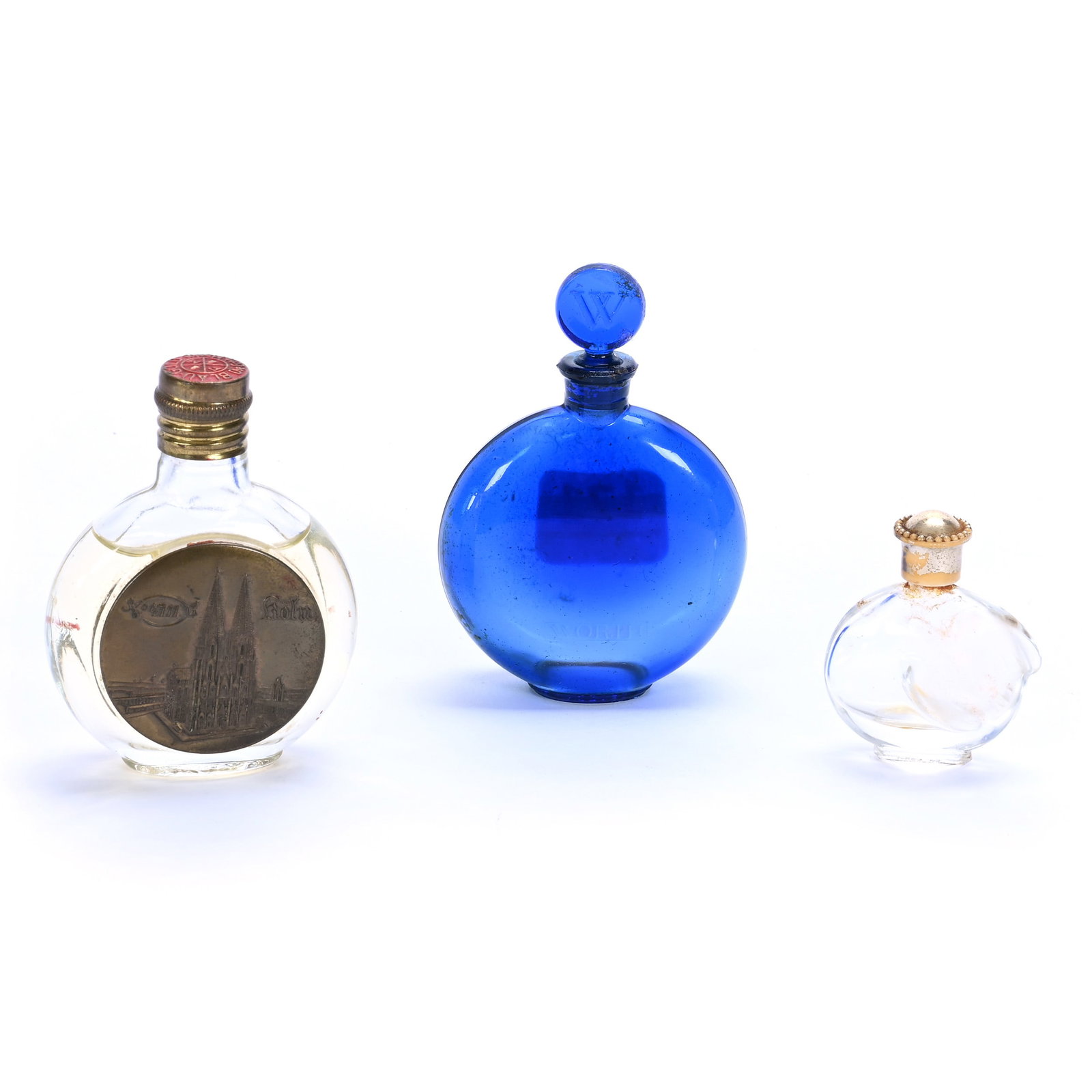 (3) Perfume Bottles: (3) Perfume Bottles, 3.25 x 2.25 x 1 Inches, (1) Solid Blue, Marked Lalique And Also Marked Worth, (1) 3" German, Marked 4711 With Cathedral Emblem, And (1) Miniature Nina Ricci Perfume, 0.3 Pounds, H