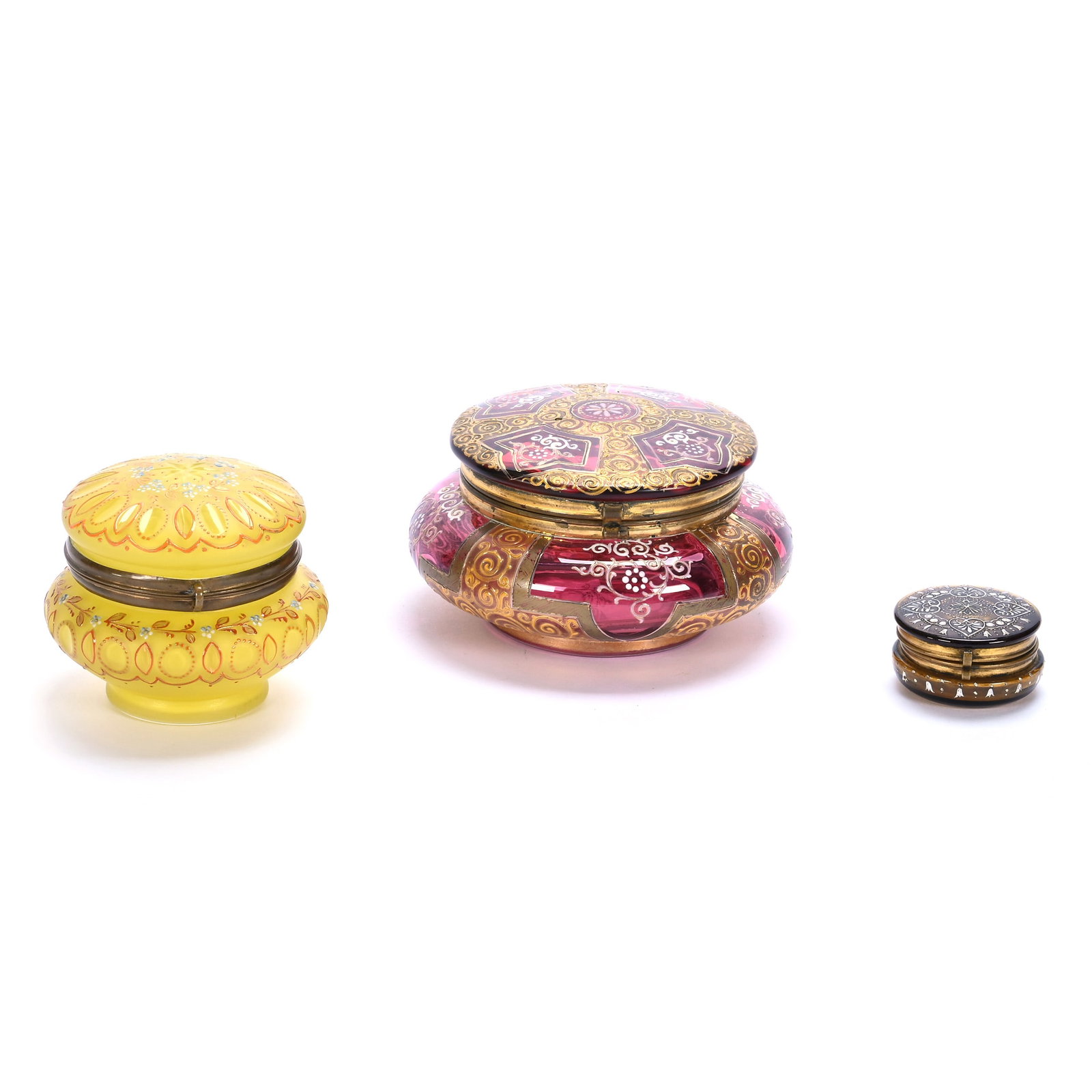 (3) Vanity Boxes, Bohemian Art Glass: (3) Vanity Boxes, Bohemian Art Glass, 5.5 x 5.5 x 3 Inches, (1) Cranberry With Gold Enamel Decor, (1) 3.5" x 3.25" Cased Yellow With Enamel Decor, And (1) 1" x 2" Solid Amber With White Enamel Decor,