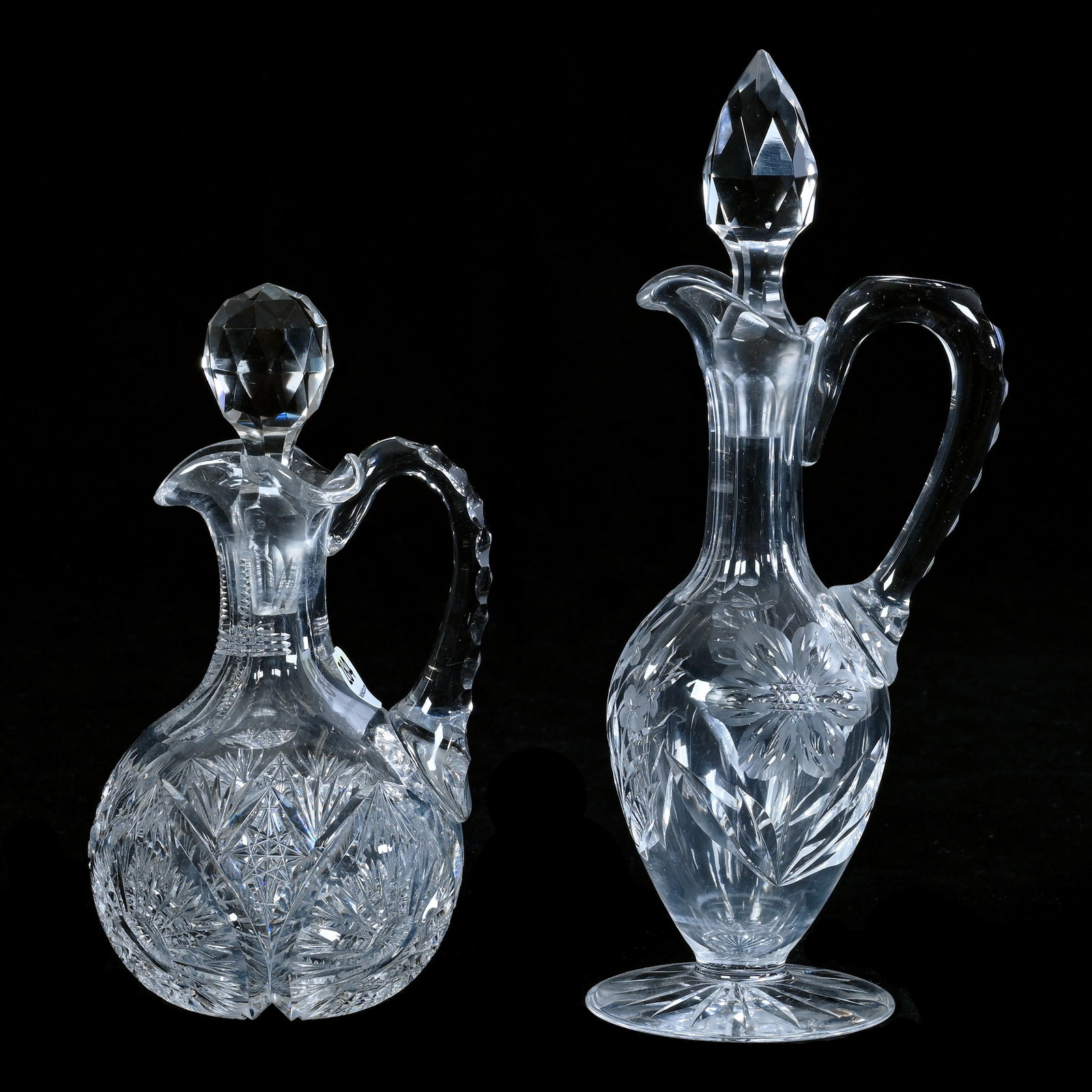 (2) Cruet Bottles, American Brilliant Cut Glass: (2) Cruet Bottles, American Brilliant Cut Glass, 9 x 3.5 x 3 Inches, (1) Pedestal Cruet With Engraved Floral Motif, (1) 7" Cruet With Sunburst Design, Stopper Plug Chips, 2.6 Pounds, Robert H. Meyer E