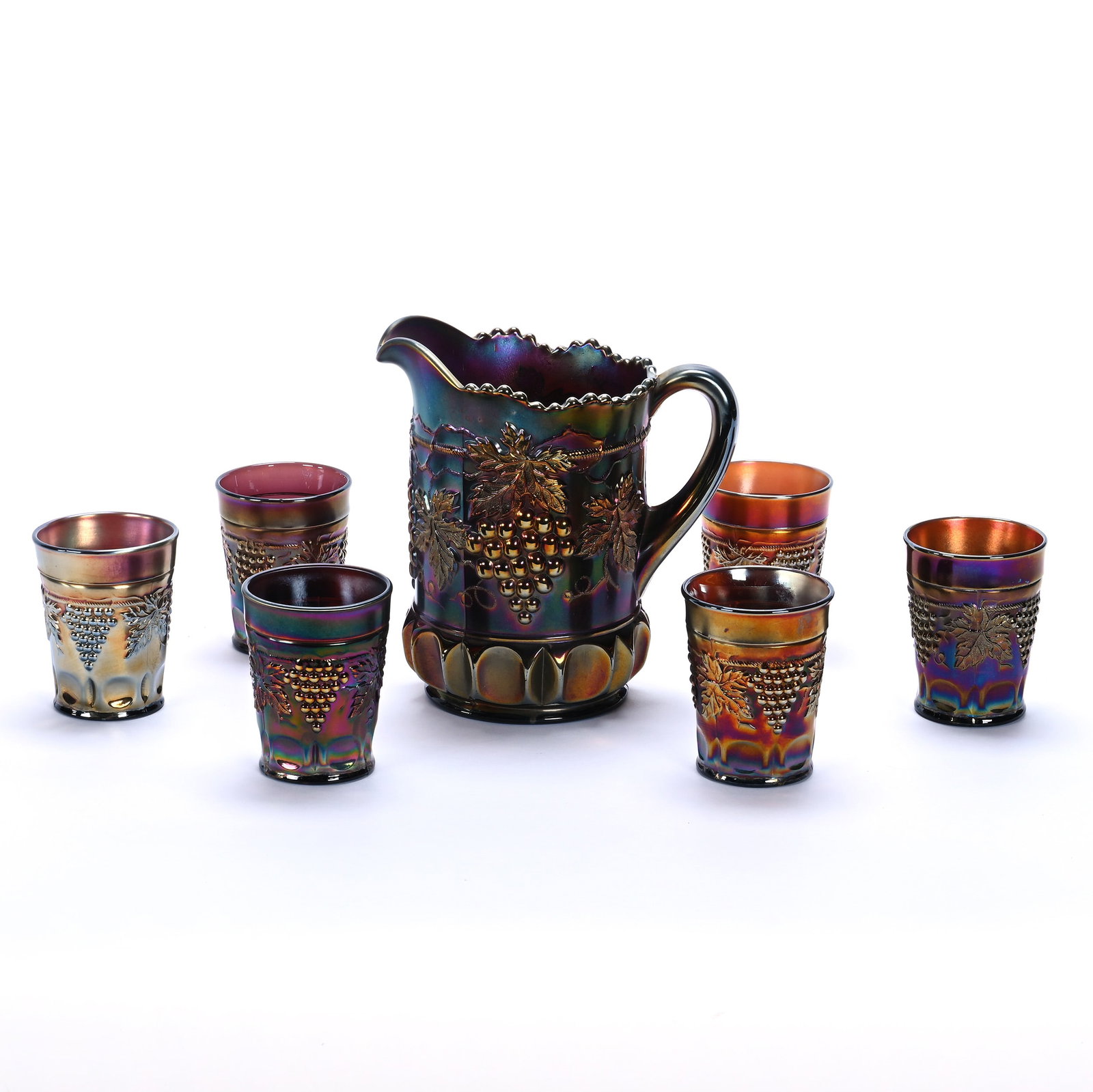 Water Set, Carnival Glass Grape And Cable Pattern By Northwood, Amethyst: Water Set, Carnival Glass Grape And Cable Pattern By Northwood, Amethyst, 8.25 x 7.75 x 5.25 Inches, Set Includes Pitcher And (6) 4" Tumblers, 7 Pounds, John And Doris Carty Estate Collection, IA,