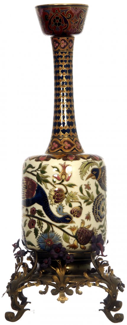 RARE 26" ZSOLNAY CERAMIC VASE FITTED ON ELABORATE FLORA: RARE 26" ZSOLNAY CERAMIC VASE FITTED ON ELABORATE FLORAL BRASS BASE VASE FEATURES TROPICAL BIRD AND PEACOCK ON FLORAL FIELD - CIRCA 1900 - EXCELLENT CONDITION - base missing minor metal pieces