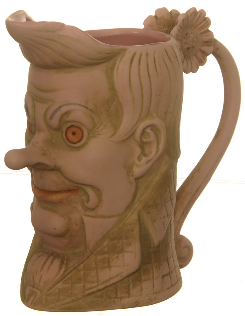 3 1/2" UNMARKED SCHAFER & VATER FIGURAL CREAMER: 3 1/2" UNMARKED SCHAFER & VATER FIGURAL CREAMER FIGURE OF LONG NOSE QUESTIONABLE CHARACTER MAN - PINK AND GREEN TONES - SPOUT CHIP