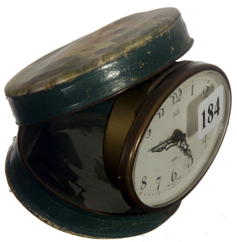 3 1/2" GERMAN TRAVEL ALARM CLOCK: 3 1/2" GERMAN TRAVEL ALARM CLOCK ELGIN WORKS - FABRIC SCENE OF WOMAN IN SWING