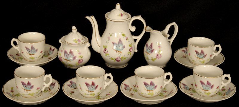 FIFTEEN PIECE CHILD'S TEA SET: FIFTEEN PIECE CHILD'S TEA SET UNMARKED GERMAN - WHITE PORCELAIN WITH BUTTERFLY AND FLORAL DECOR - 4" TEA POT, CREAMER, SUGAR, (6) CUPS AND (6) SAUCERS