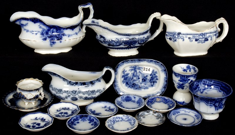 (17) FLOW BLUE ITEMS: (1) DEVON PATTERN GRAVY - (1) MADRAS PATTERN GRAVY - (1) DELFT PATTERN GRAVY - (1) SAVOY PATTERN GRAVY - (1) CHILDS TRAY - (1) EGG CUP - (9) BUTTER PATS - AND MORE