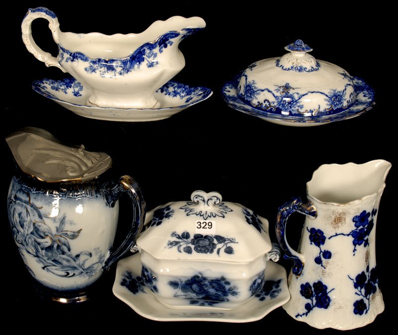 (5) FLOW BLUE ITEMS: (1) 7 1/2" PITCHER WITH PEWTER LID - (1) LINDA PATTERN GRAVY BOAT & UNDERPLATE - (1) 7" FLORAL PITCHER - (1) MANILA PATTERN BUTTERDISH WITH DRAIN (HARD TO SEE HAIRLINE IN BASE) - (1) YORKSHIRE COVERED