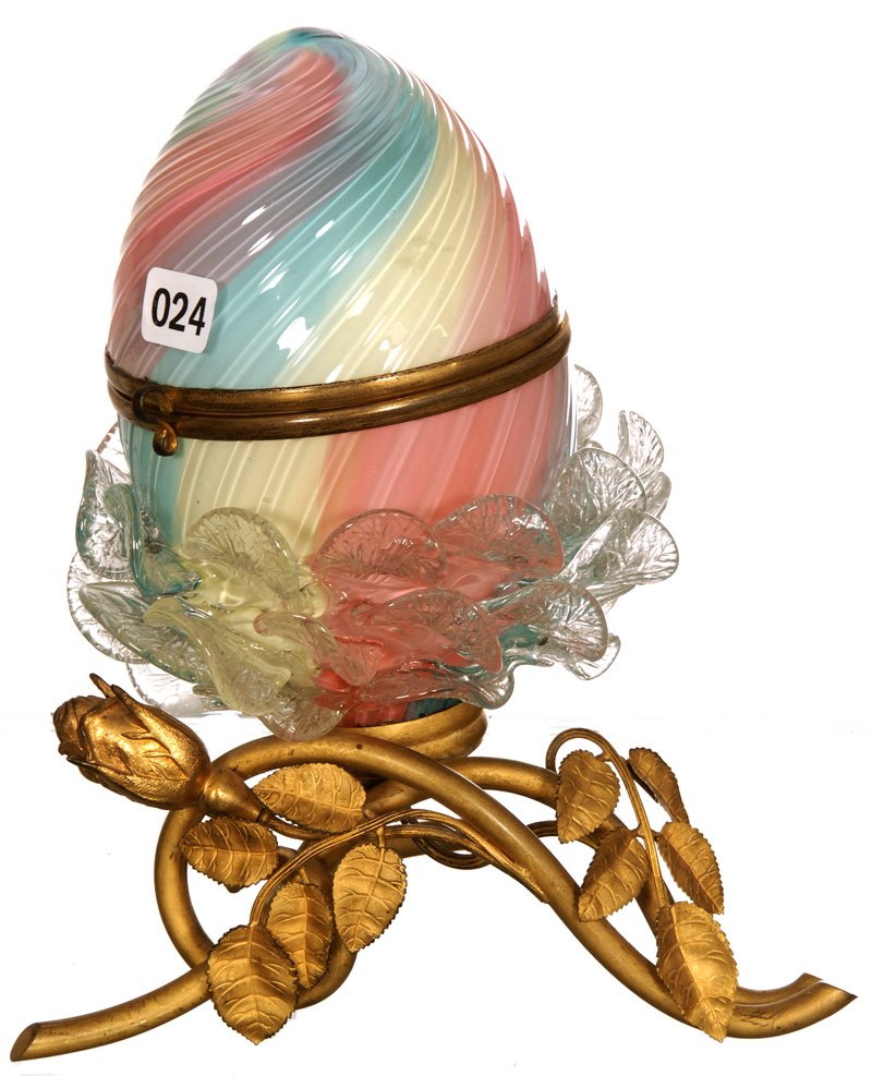 8 1/2" CASED ART GLASS RAINBOW EGG SHAPED HINGED JEWEL: 8 1/2" CASED ART GLASS RAINBOW EGG SHAPED HINGED JEWEL BOX SET ON GILT FIGURAL ROSE BRANCH BASE - CLEAR APPLIED RIGOREE BLOSSOM - WHITE INTERIOR - VERY NICE