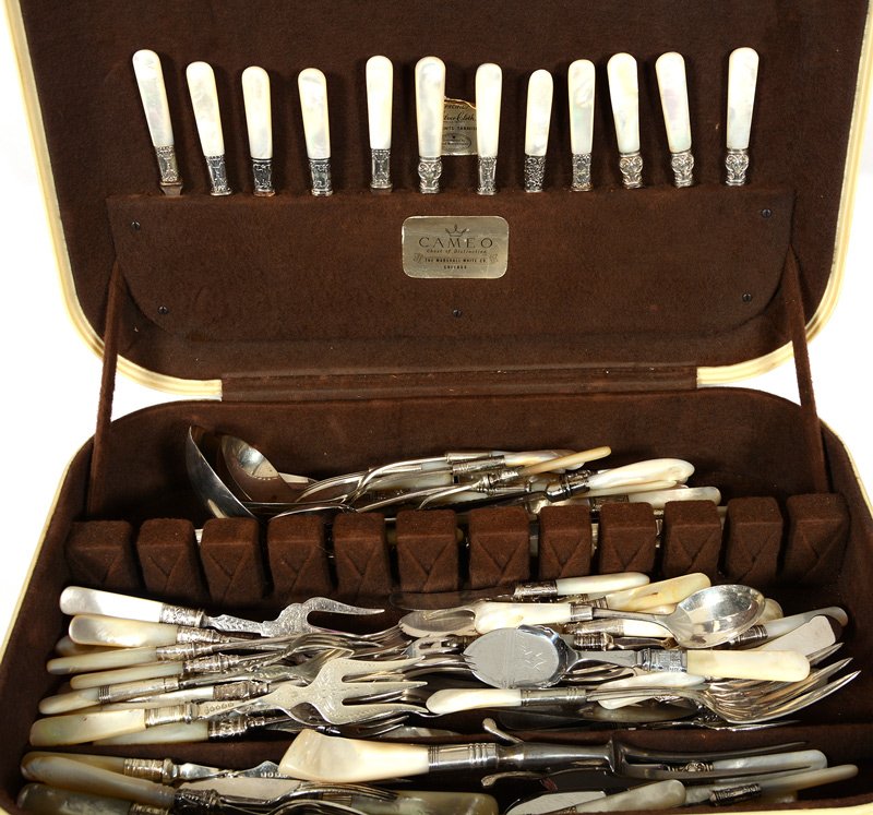 77 PIECES OF MOTHER OF PEARL AND SILVER FLATWARE IN: 77 PIECES OF MOTHER OF PEARL AND SILVER FLATWARE IN FAUX IVORY BOX MINIMUM OF FIVE DIFFERENT PATTERNS THAT RESEMBLE ONE ANOTHER CLOSELY - NUMEROUS SERVING FORKS, ASSORTED KNIVES, LADLES, PIE AND CAKE 