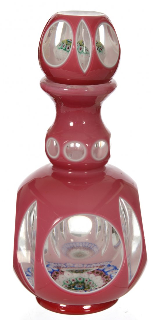 6 3/4" CASED ART GLASS PAPERWEIGHT COLOGNE BOTTLE: 6 3/4" CASED ART GLASS PAPERWEIGHT COLOGNE BOTTLE PINK AND WHITE OVERLAY WITH CUT "WINDOW" DESIGN - MILLEFIORI FIELD FEATURED IN BASE AND STOPPER