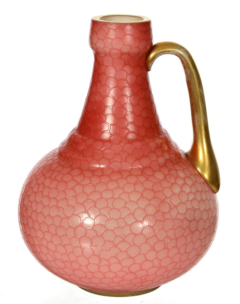 7" UNIQUE ART GLASS HANDLED JUG: 7" UNIQUE ART GLASS HANDLED JUG PINK EXTERIOR WITH CAMEO CARVED FISH SCALE DESIGN - GOLD ENAMEL HANDLE