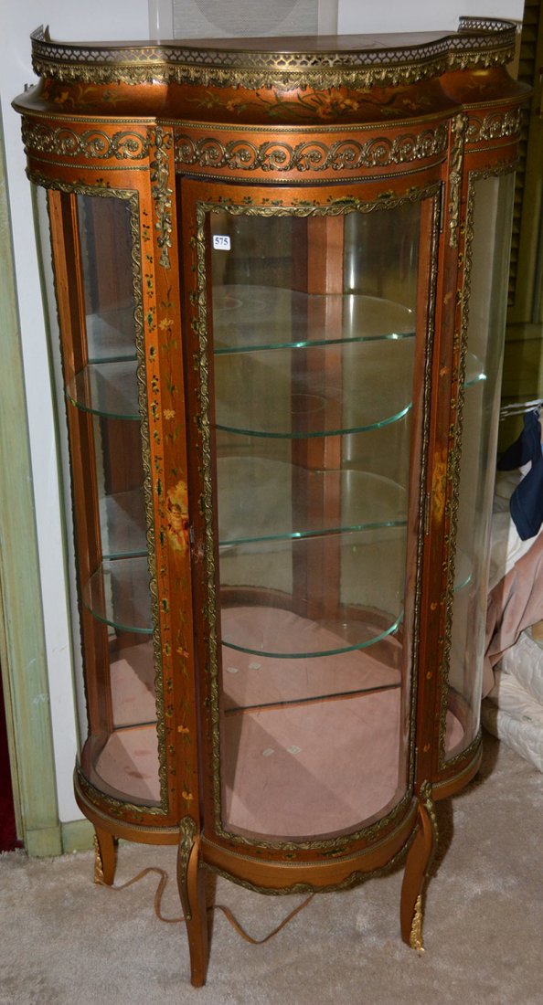 55 1/2" X 27" X 17" FRENCH THREE LEAF CLOVER LIGHTED: 55 1/2" X 27" X 17" FRENCH THREE LEAF CLOVER SHAPE LIGHTED DISPLAY CABINET GOLD BACKGROUND WITH FLORAL AND CHERUB HIGHLIGHT - NICE GILT METAL TRIM - MIRROR BACK - TWO GLASS SHELVES