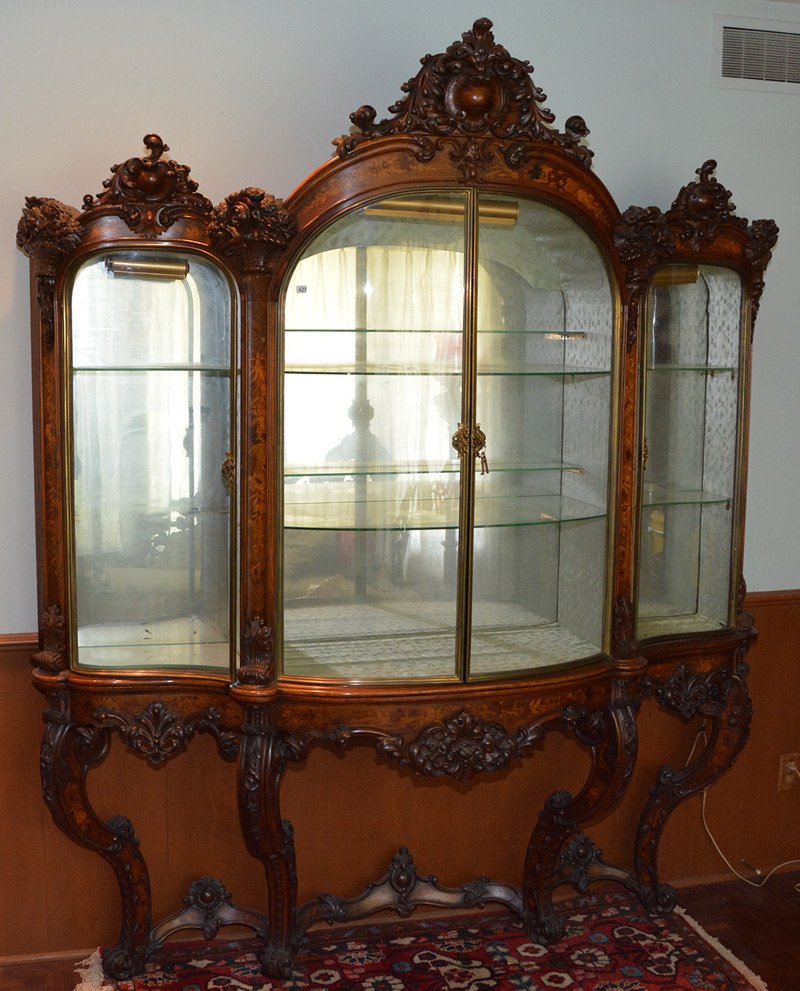 FABULOUS 86" X 74" X 18" CARVED WALL MOUNTED DISPLAY: FABULOUS 86" X 74" X 18" HIGHLY CARVED WALL MOUNTED DISPLAY CABINET FEATURES INLAY FLORAL HIGHLIGHTS - DETAIL CARVING OF FLORAL BASKETS - LIGHTED GLASS TOP SEPARATES FROM SOLID WOOD BASE - EIGHT GLASS