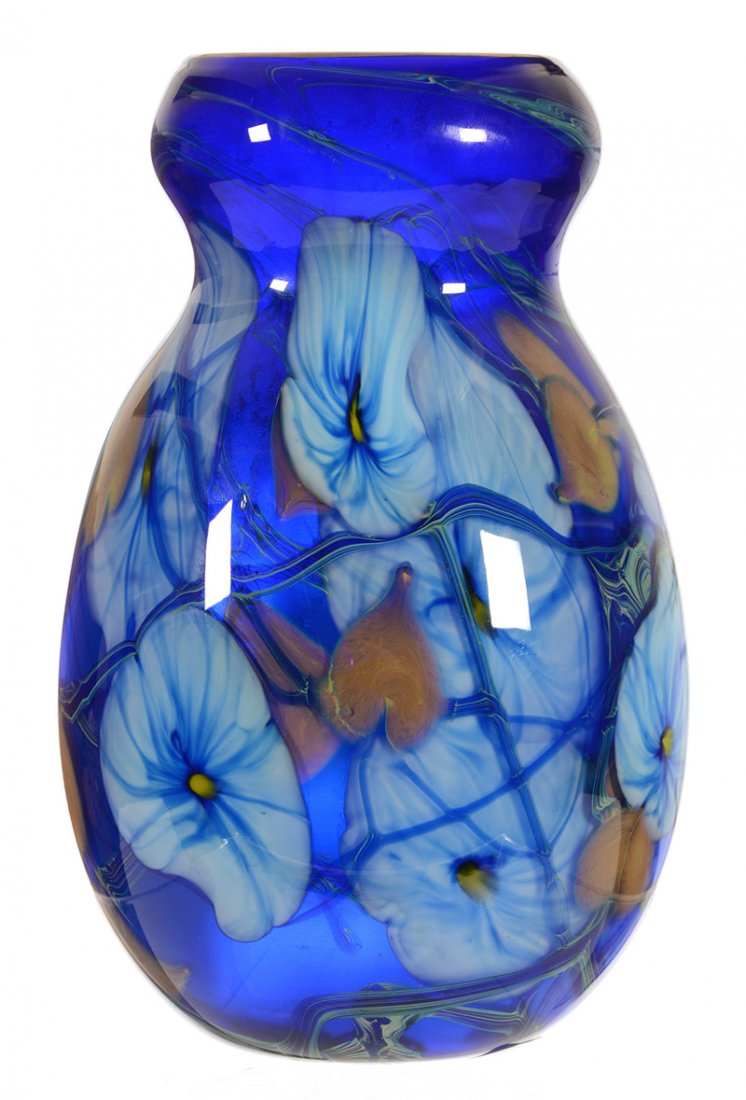 9" SIGNED CHARLES LOTTON ART GLASS "MULTI FLORA" VASE: 9" SIGNED CHARLES LOTTON ART GLASS "MULTI FLORA" VASE - COBALT BLUE BACKGROUND W/ BLUE & WHITE FLORAL, GOLD & BLUE HEART & VINE DECOR - DATED 1976