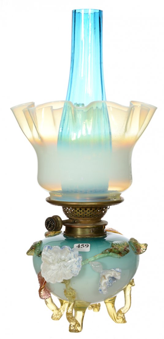 17" ART GLASS KEROSENE LAMP: 17" ART GLASS KEROSENE LAMP STEVENS AND WILLIAMS FONT FEATURING BLUE CASED BODY WITH APPLIED LEAF AND FLORAL DECOR - WHITE OPAQUE RUFFLED SHADE - BLUE ART GLASS CHIMNEY