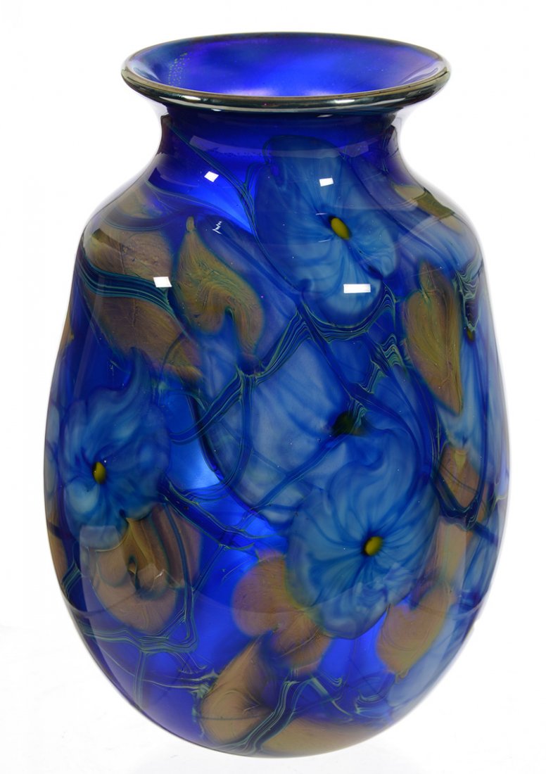 8" SIGNED CHARLES LOTTON ART GLASS "MULTI FLORA" VASE: 8" SIGNED CHARLES LOTTON ART GLASS "MULTI FLORA" VASE - COBALT BLUE BACKGROUND W/ BLUE & WHITE BLOSSOM, BLUE VINE & GOLD HEART DECOR - DATED 1976