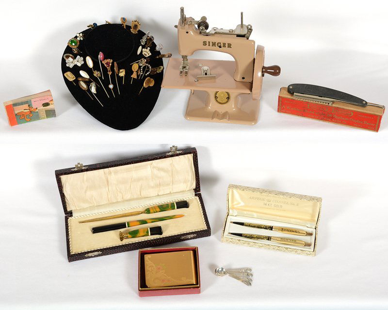 BOX LOT: BOX LOT OVER (35) VINTAGE STICK PINS - (4) STERLING SALT SPOONS - ARPEGE 14K GOLD TWO PIECE PEN SET - DESK SET IN BOX - DOUBLE SIDED FLIP BOOK - 6 1/2" X 6 1/2" SINGER MINIATURE SEWING MACHINE - ELGIN